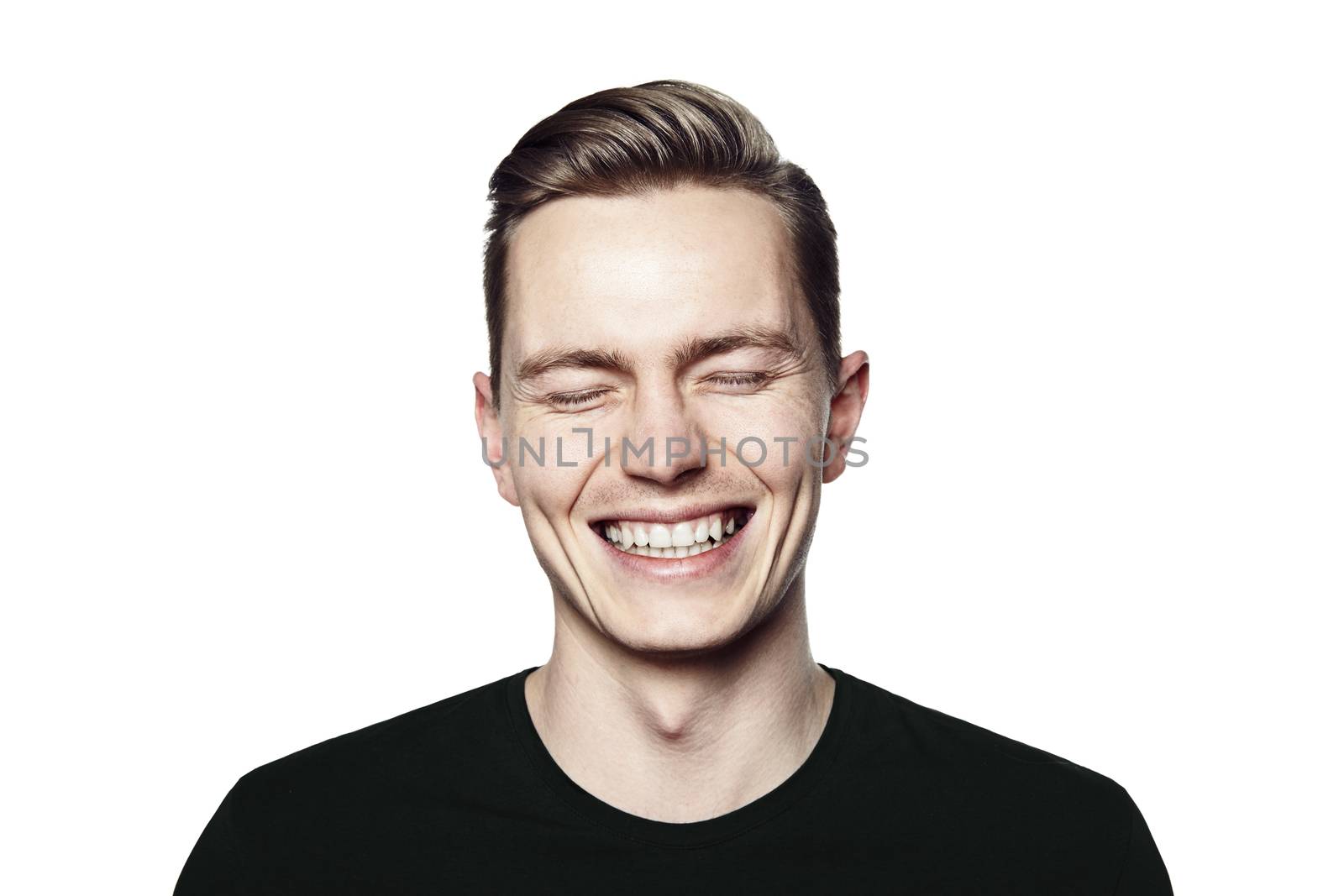 Studio shot of young man smiling to camera. Isolated on white background. Horizontal format, he is looking to the camera, he is wearing a black T-shirt.
