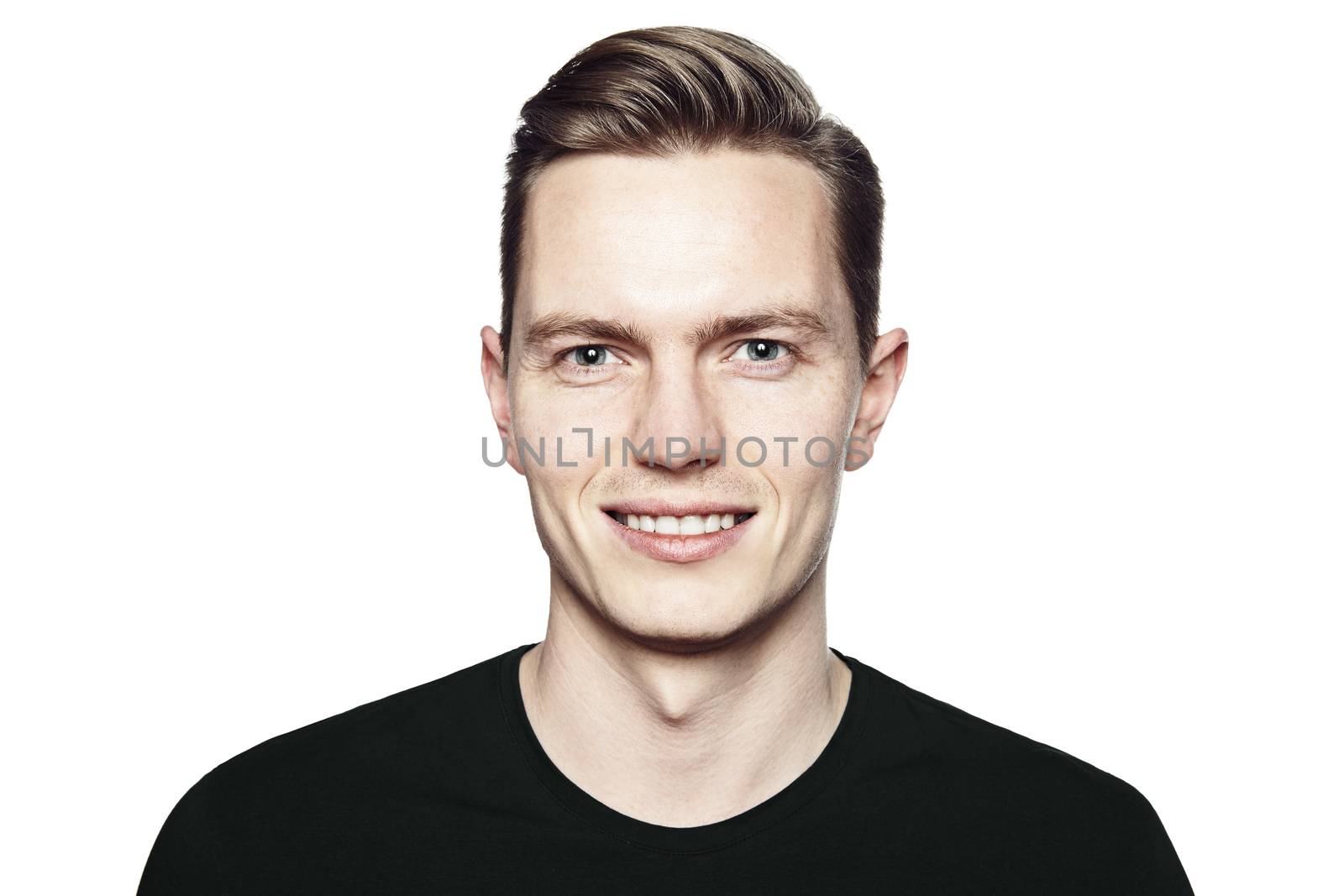 Studio shot of young man smiling to camera. Isolated on white background. Horizontal format, he is looking to the camera, he is wearing a black T-shirt.
