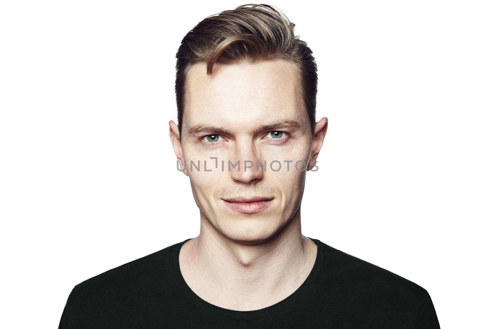 Young man looking at the camera. Isolated on white background. Horizontal format, he has a serious face, he is wearing a black T-shirt.
