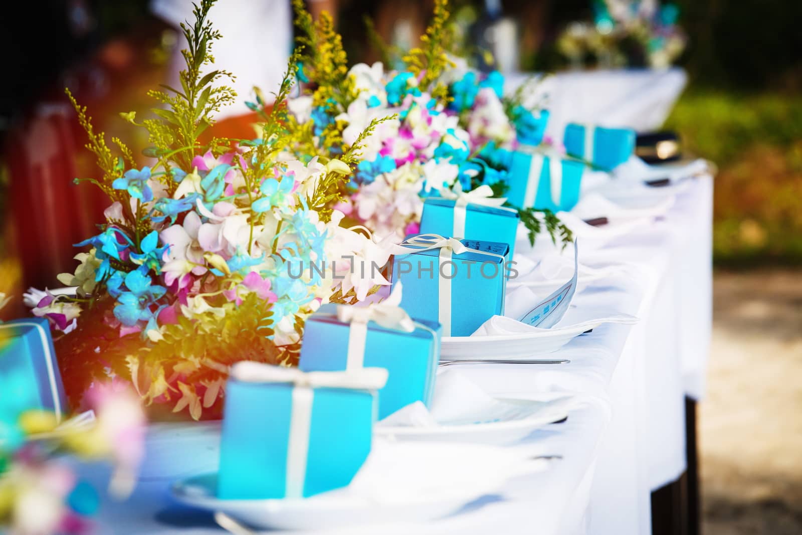 Laid wedding table with gifts and flowers