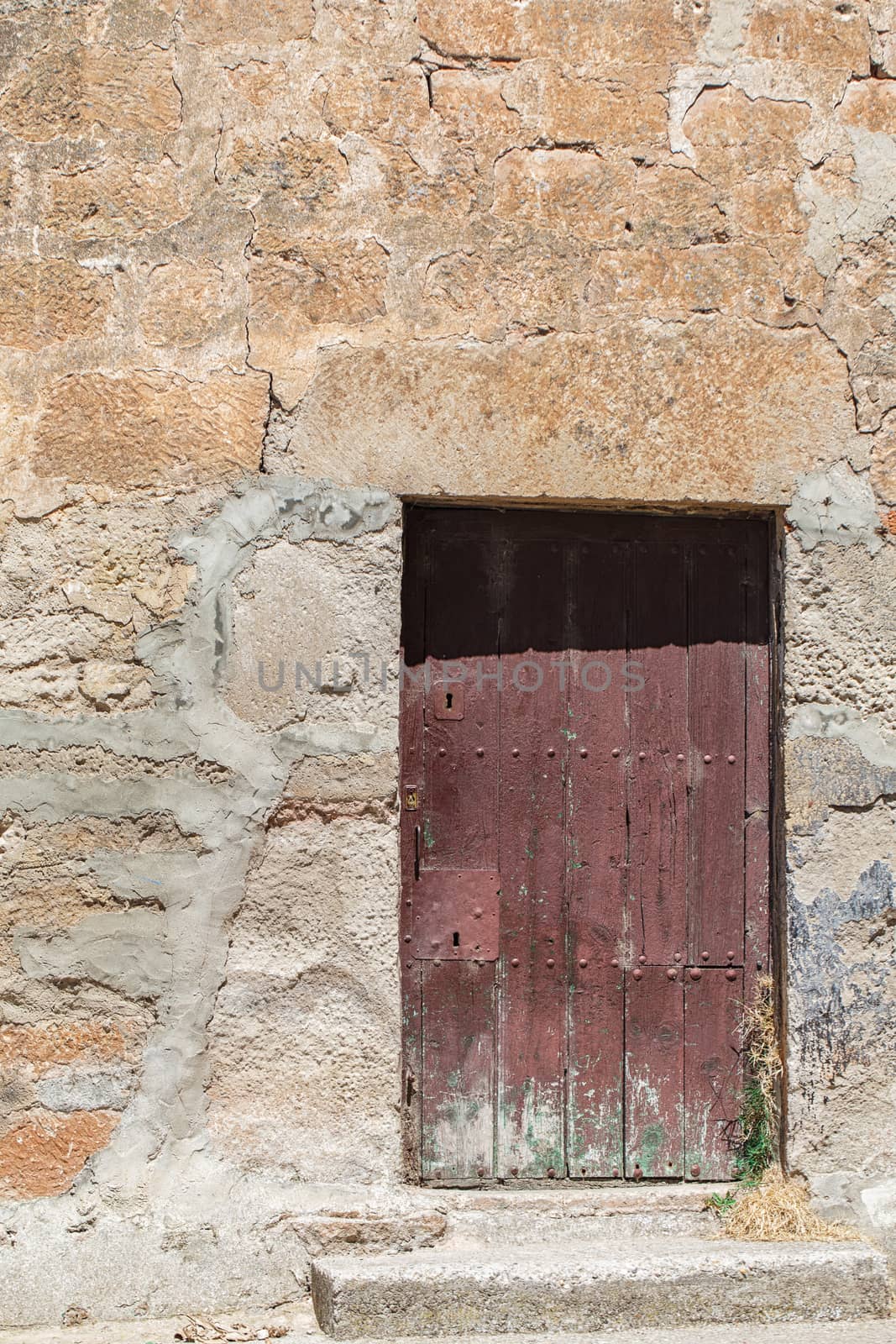 Old rustic wall with wooden textured door 