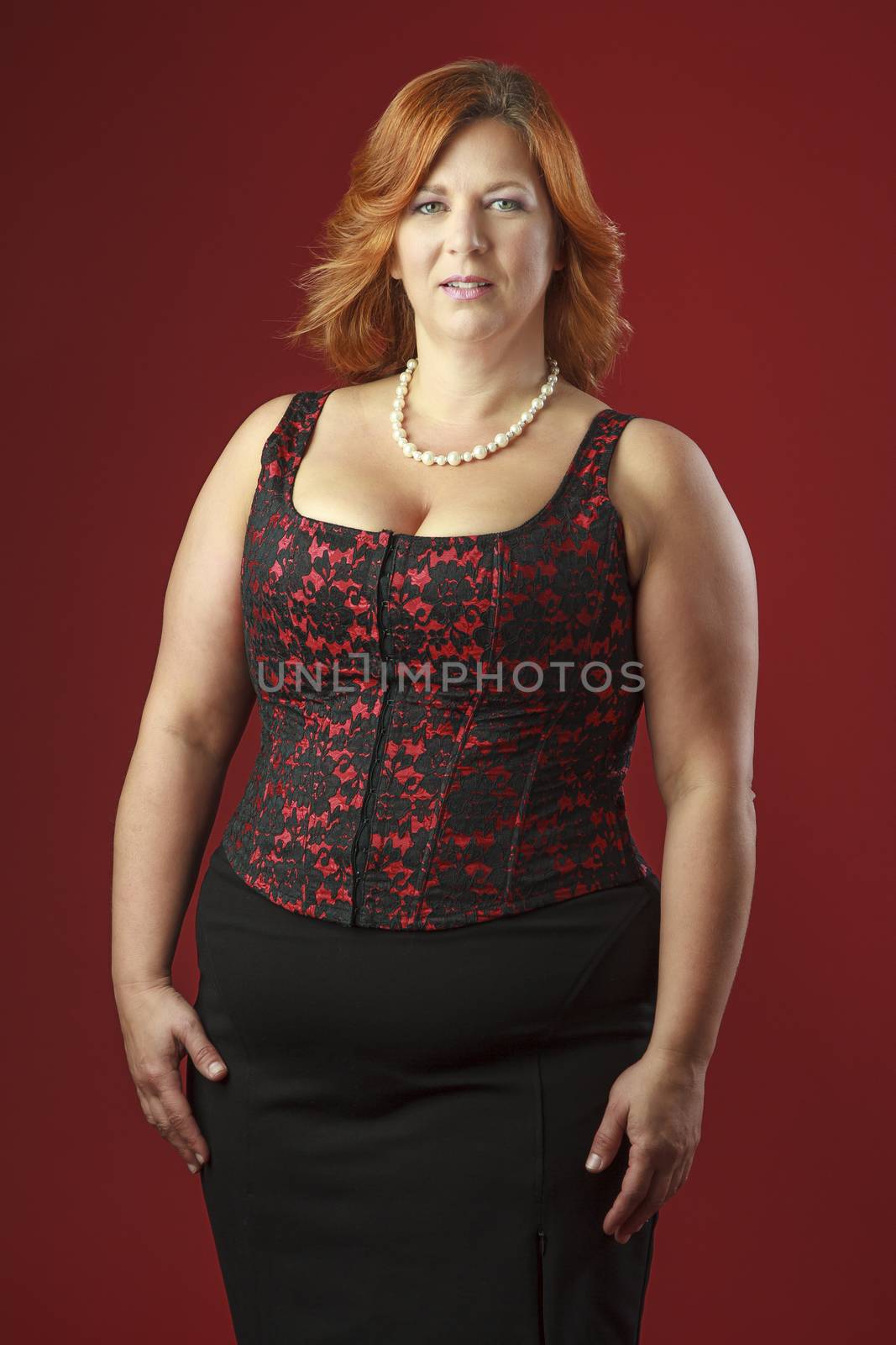 Woman in her fortie wearing a red corset