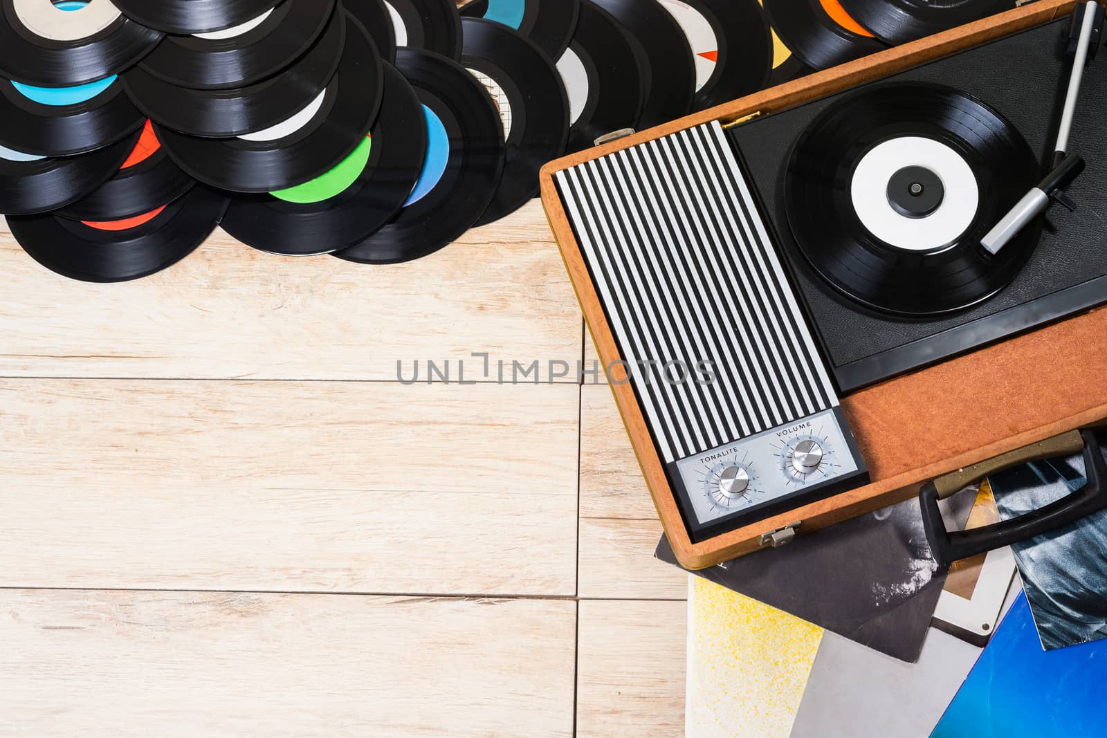 Gramophone with a vinyl records on wooden table, top view and copy space.