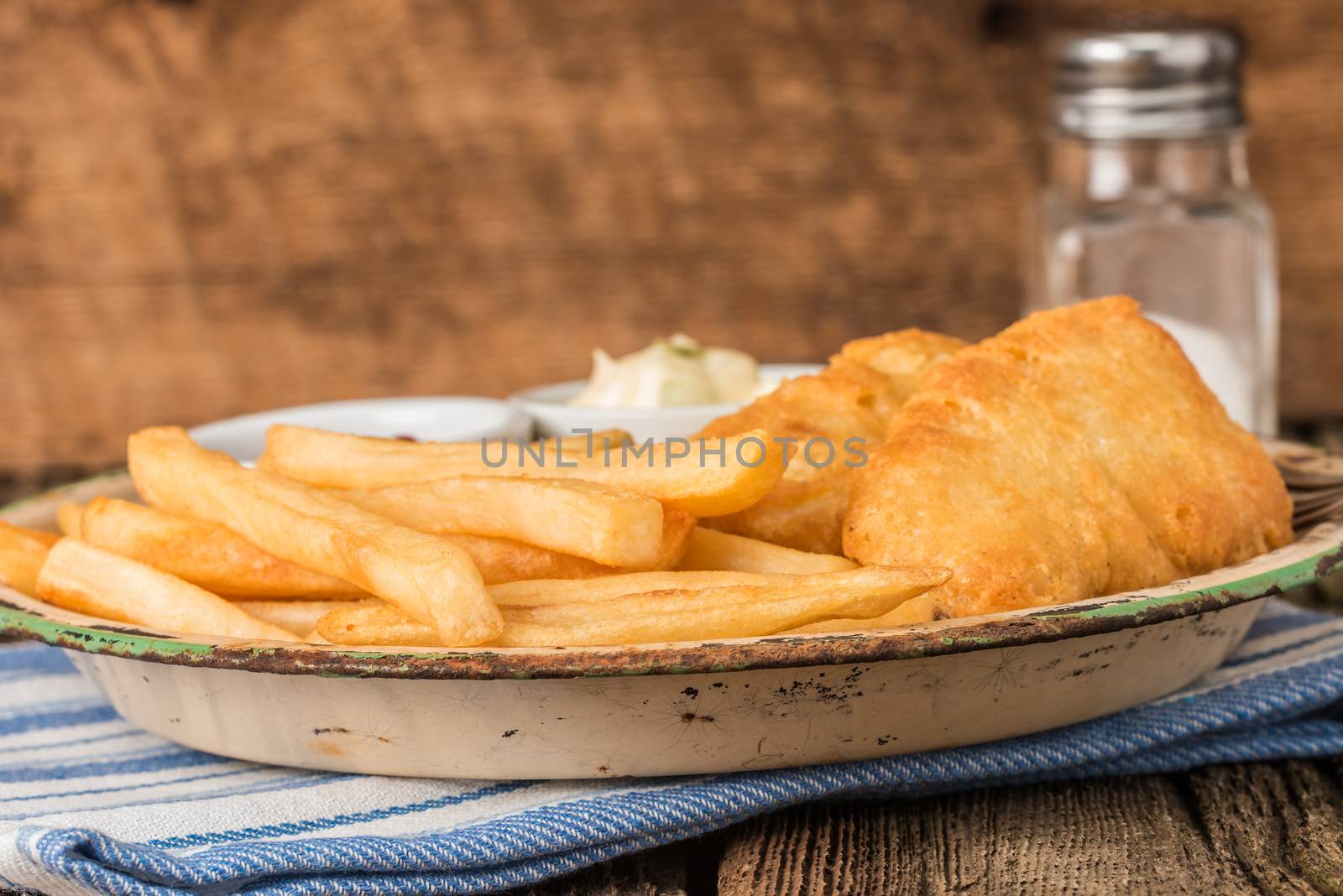 Deep fried potatoes served with battered fish.