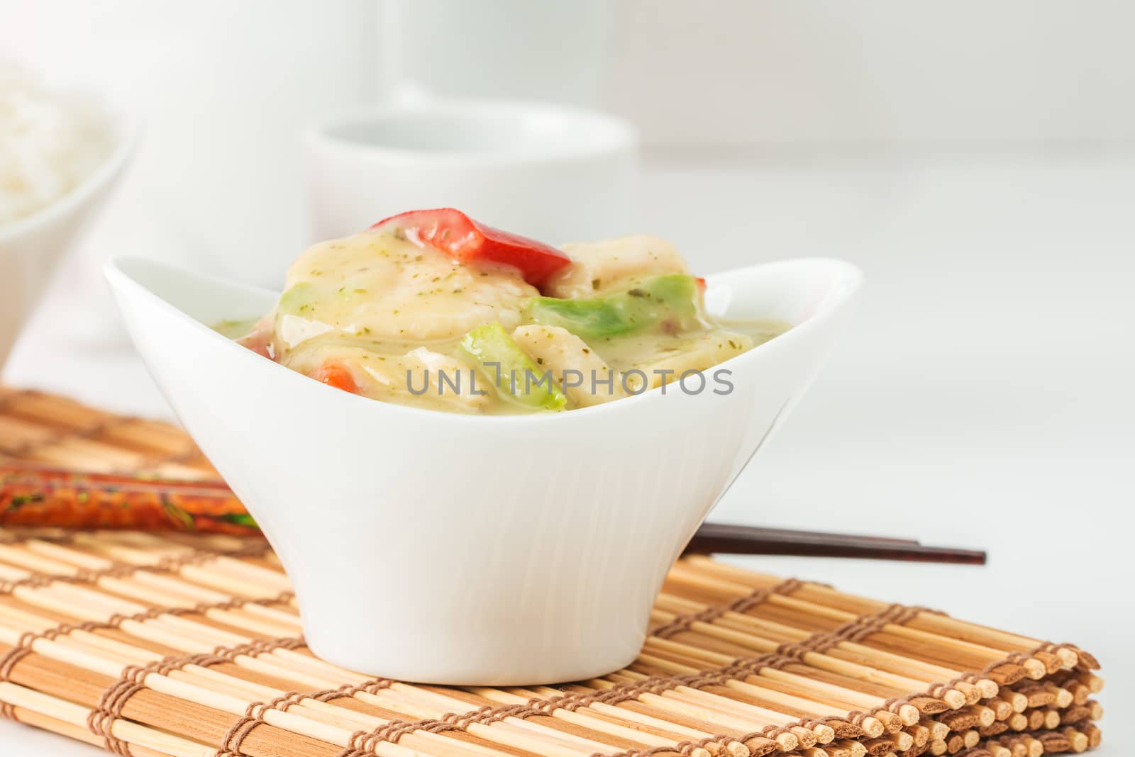 Bowl of green curry chicken photographed closeup.