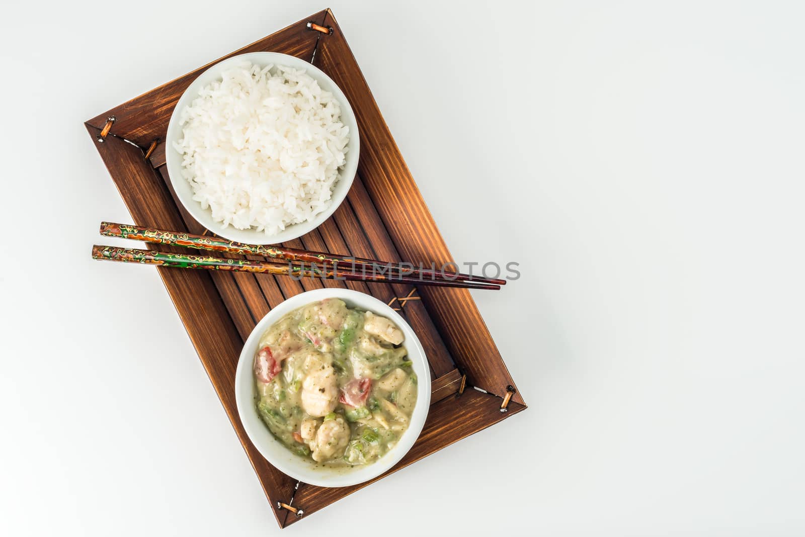 Green curry chicken and white rice photographed from above.