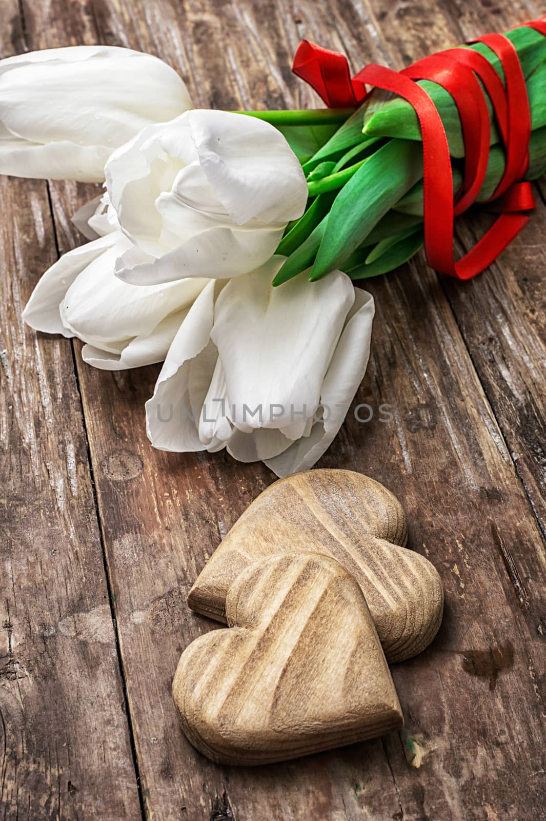 bouquet of tulips bright color and symbolic wooden heart