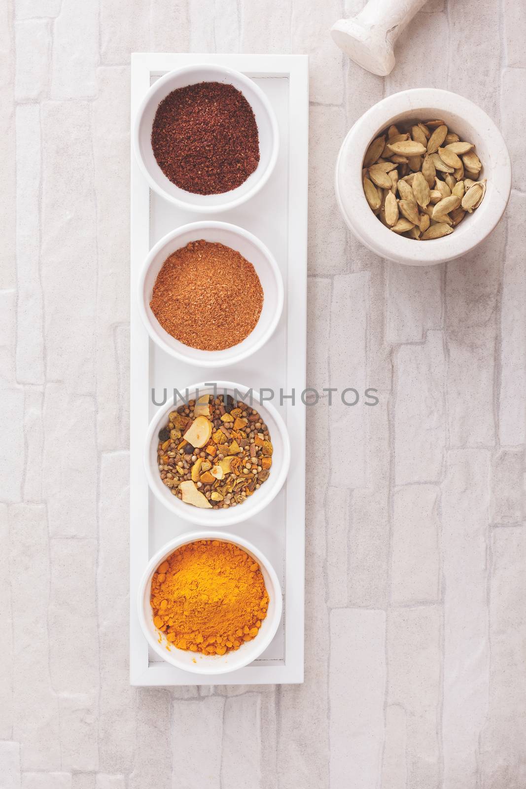 Indian spices: curry, turmeric, sumac, cardamom and tandoori. over rustic background. Top view, blank space, vintage toned image. Natural light