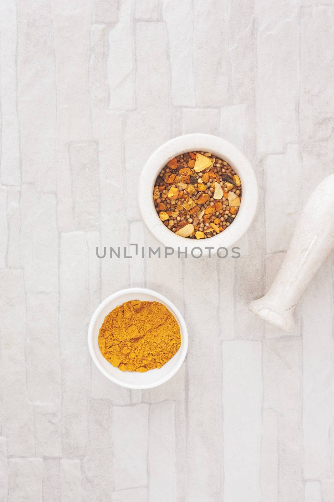 Curry in and beside a mortar. Top view, blank space, vintage toned image. Natural light