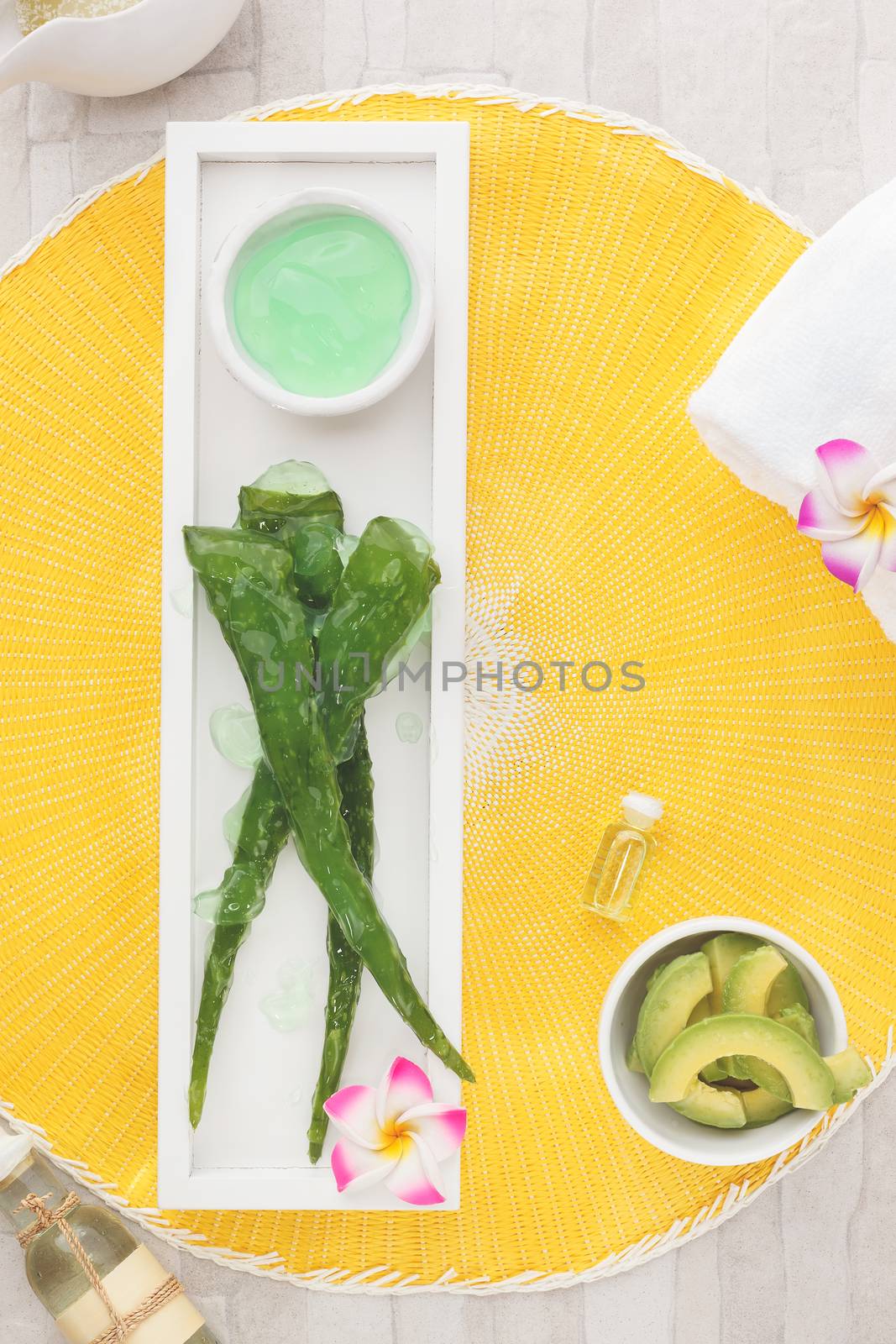 Natural spa treatment with aloe, avocado and coconut ingredients. Overhead view with copy space. Natural light