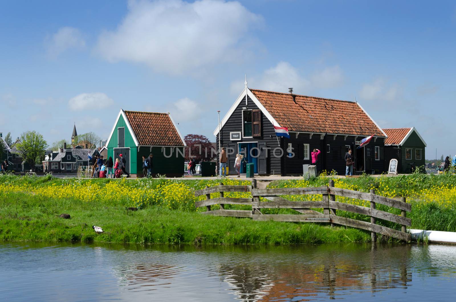 Zaanse Schans, Netherlands - May 5, 2015: Tourists visit rural houses in Zaanse Schans, Netherlands. This village is a popular touristic destination in Netherlands