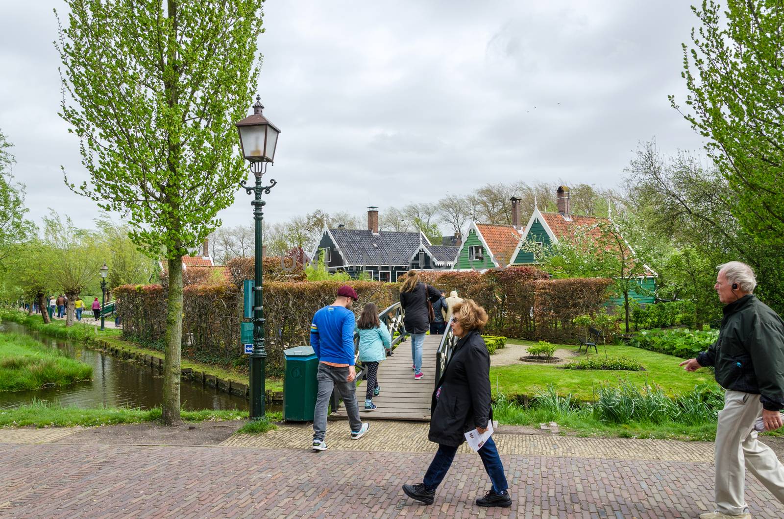 Zaanse Schans, Netherlands - May 5, 2015: Tourists visit Windmills and rural houses in Zaanse Schans by siraanamwong