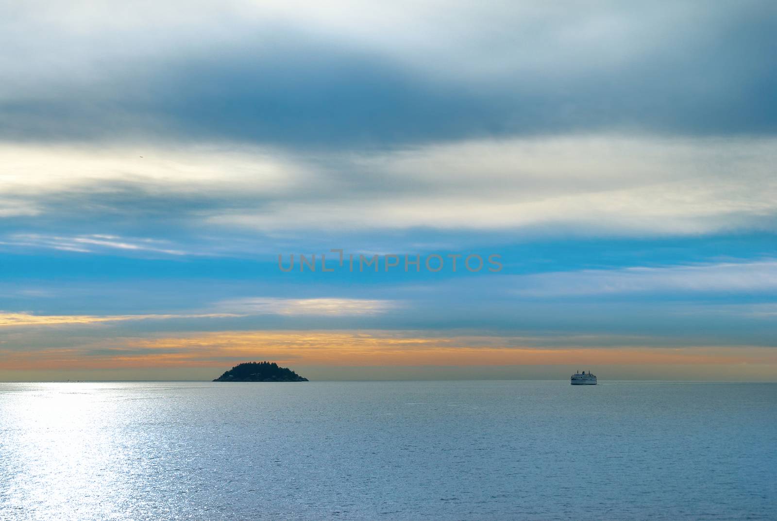 Small island in the sea. Sunset above the ocean