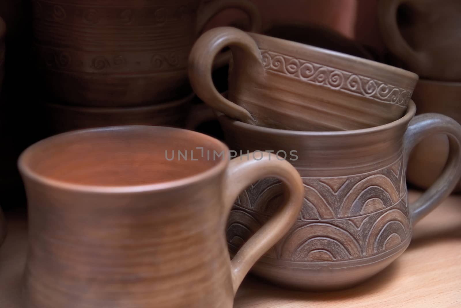 Many handmade old clay pots on the shelf.