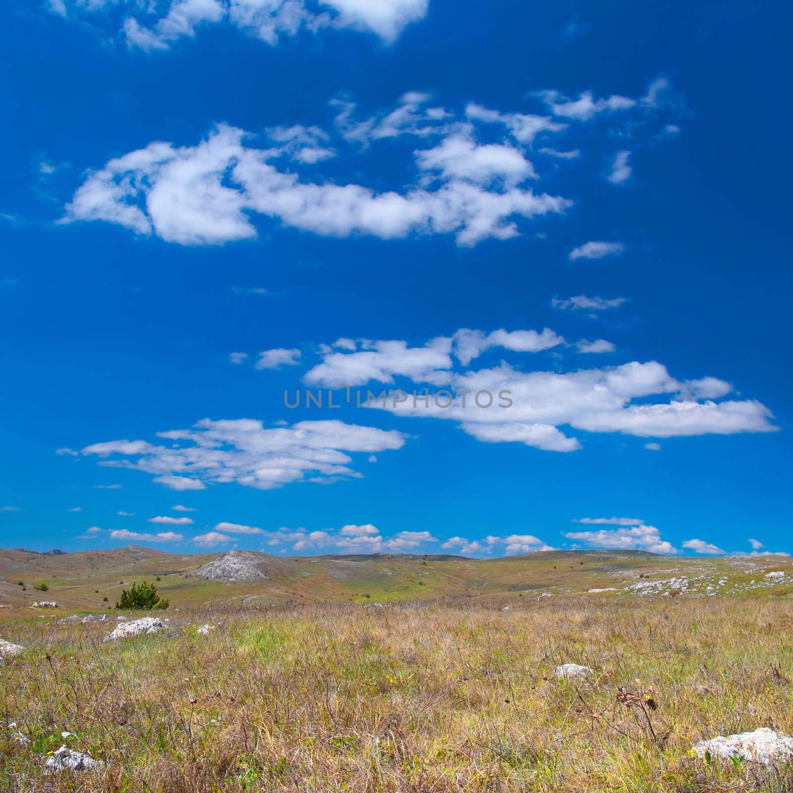 Hills with cloudscape and blue sky. Landscape.