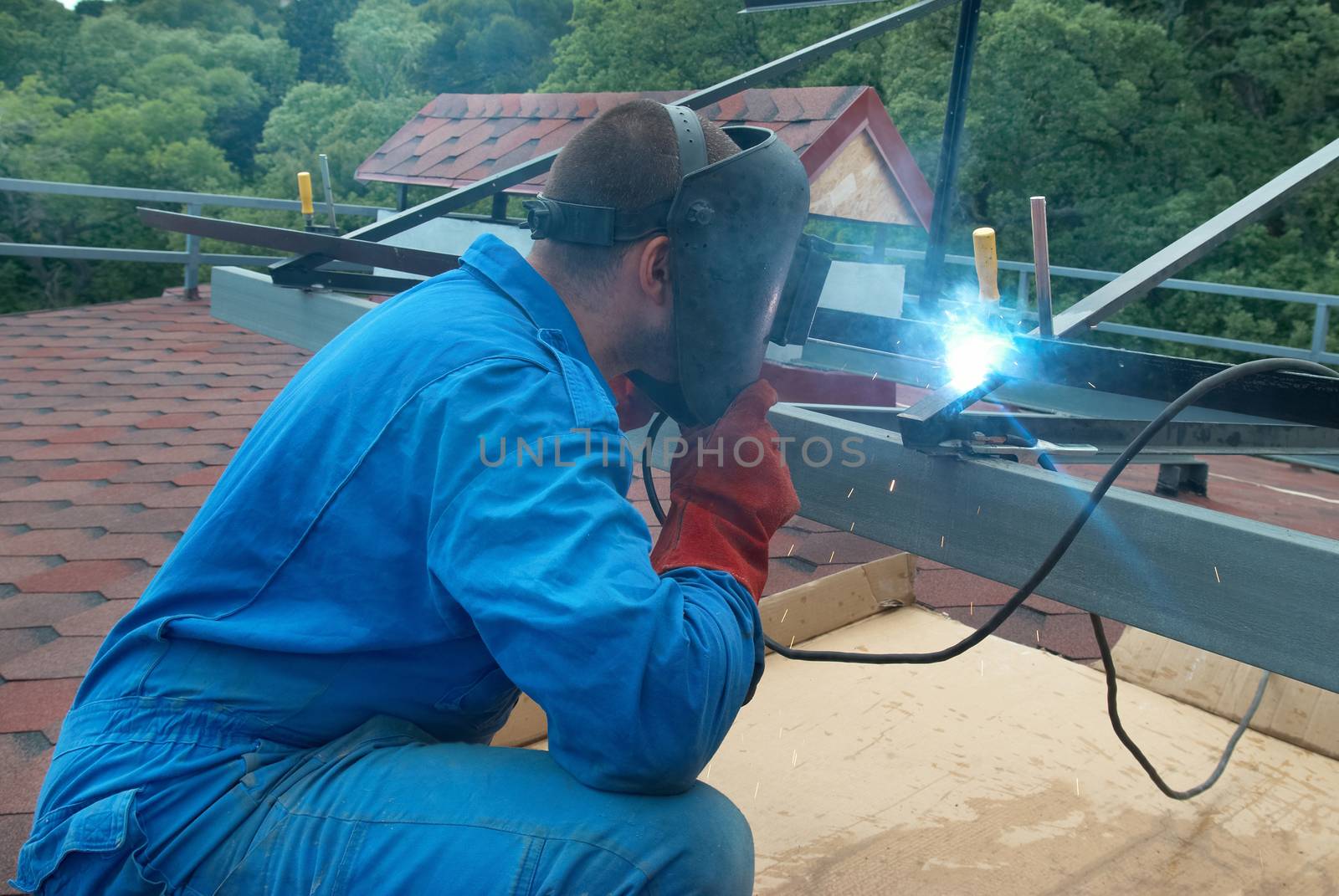 Welder at the factory working with metal construction