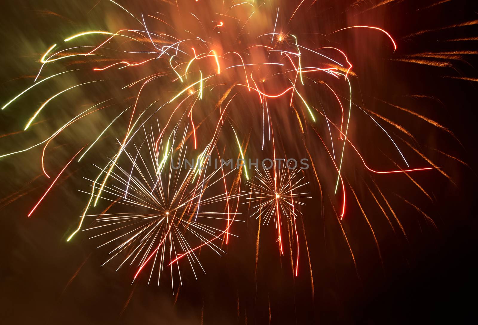 Red colorful fireworks on the black sky background. Holiday celebration.