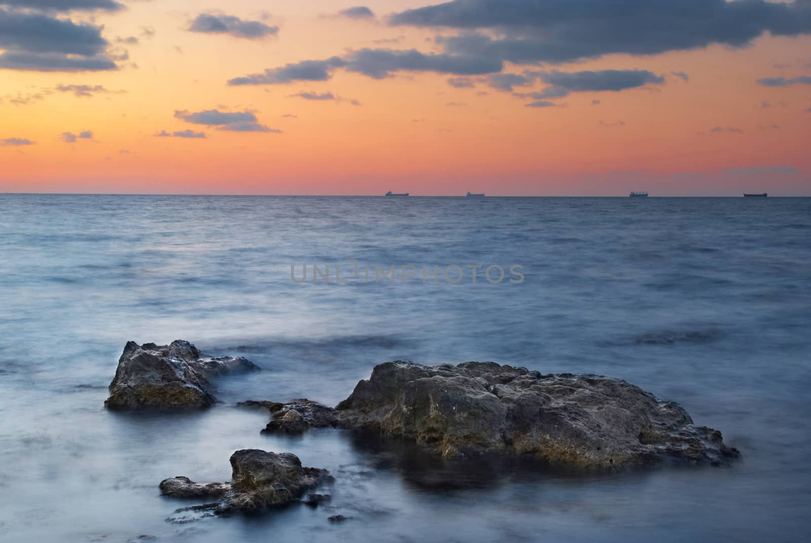 Sunset on the sea. Landscape with rocks and beautiful sky.