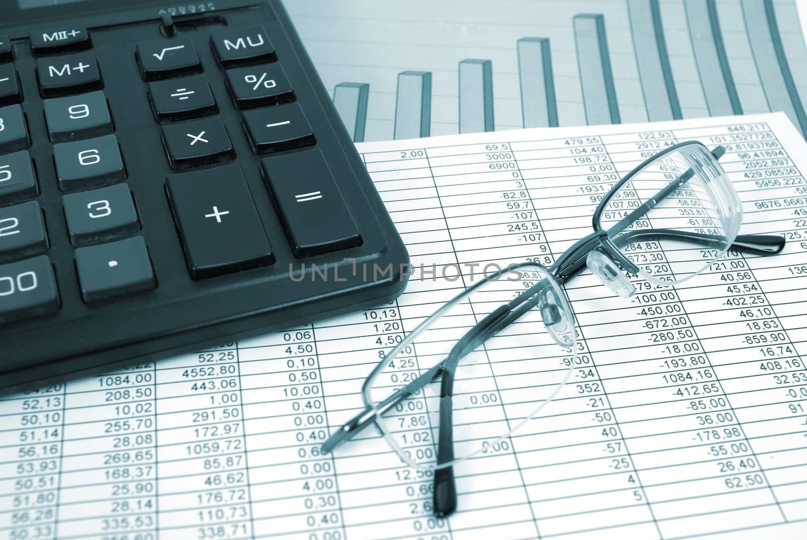 Glasses and calculator on paper table with finance diagram
