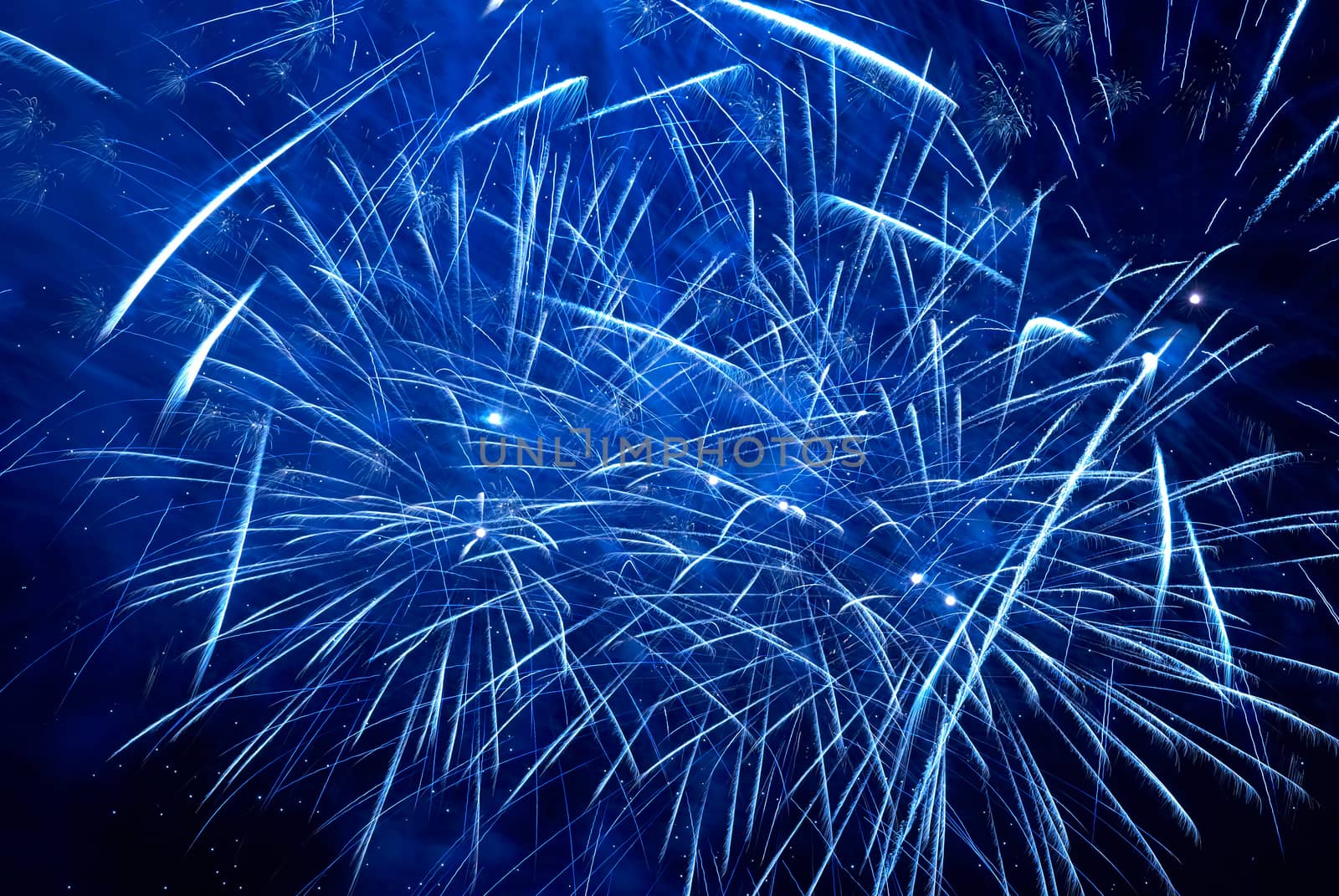 Blue colorful holiday fireworks on the black sky background.