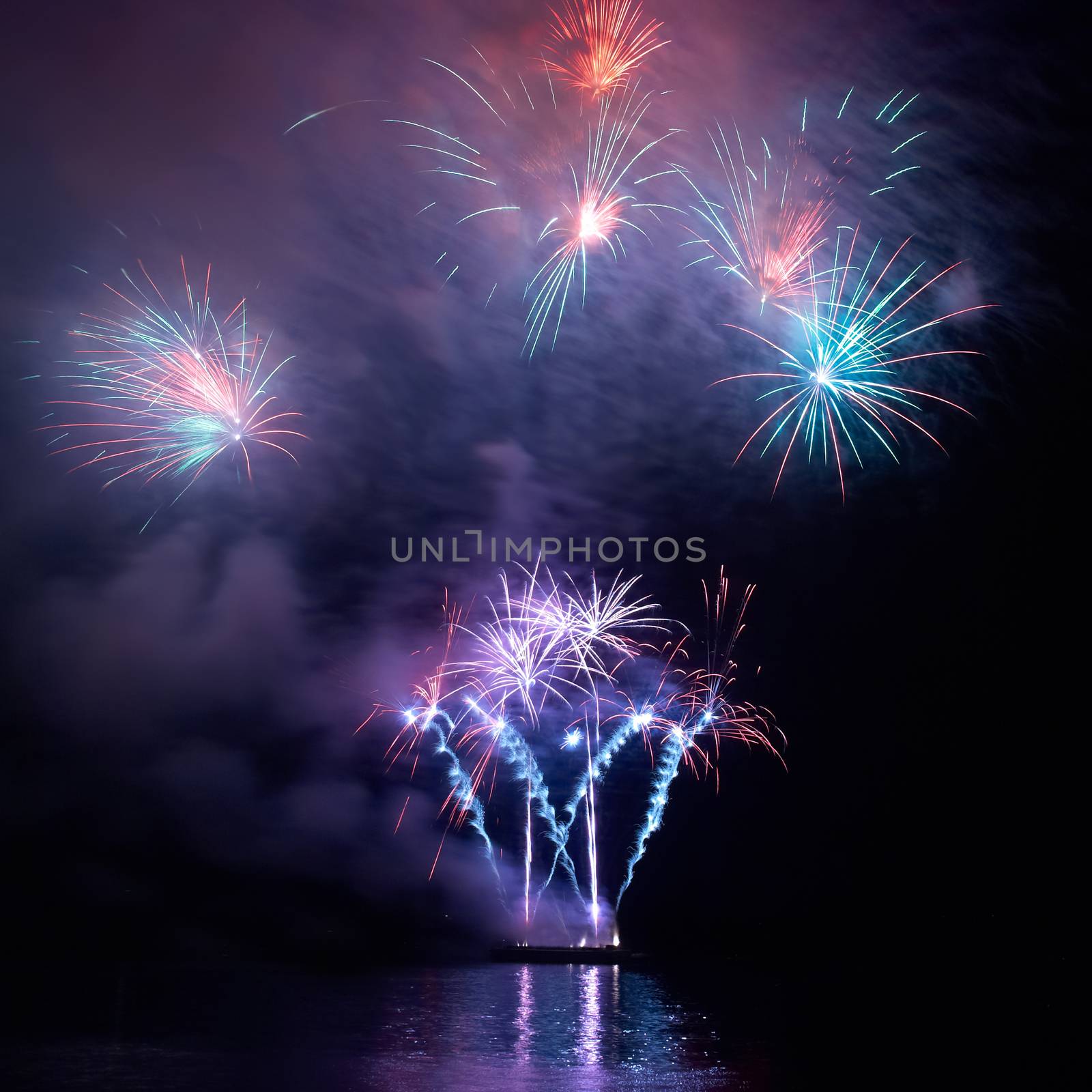 Colorful holiday fireworks on the black sky background.