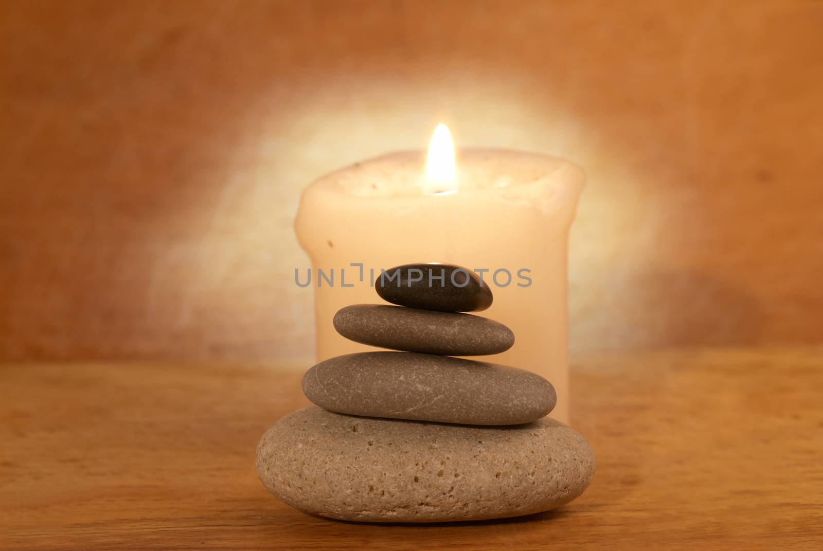 Spa concept with candle, zen stones and wooden background