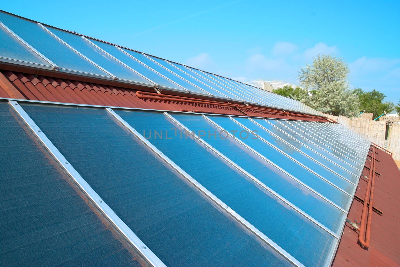 Solar water heating system on the red roof. Gelio panels.