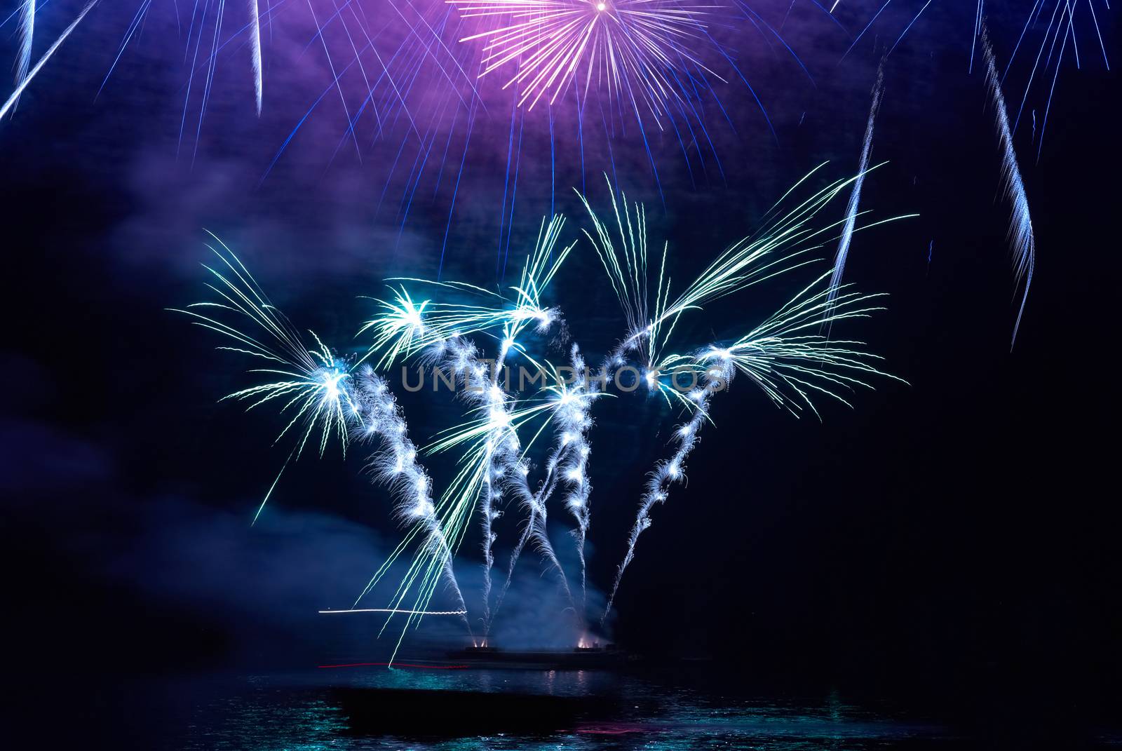 Colorful holiday fireworks on the black sky background.