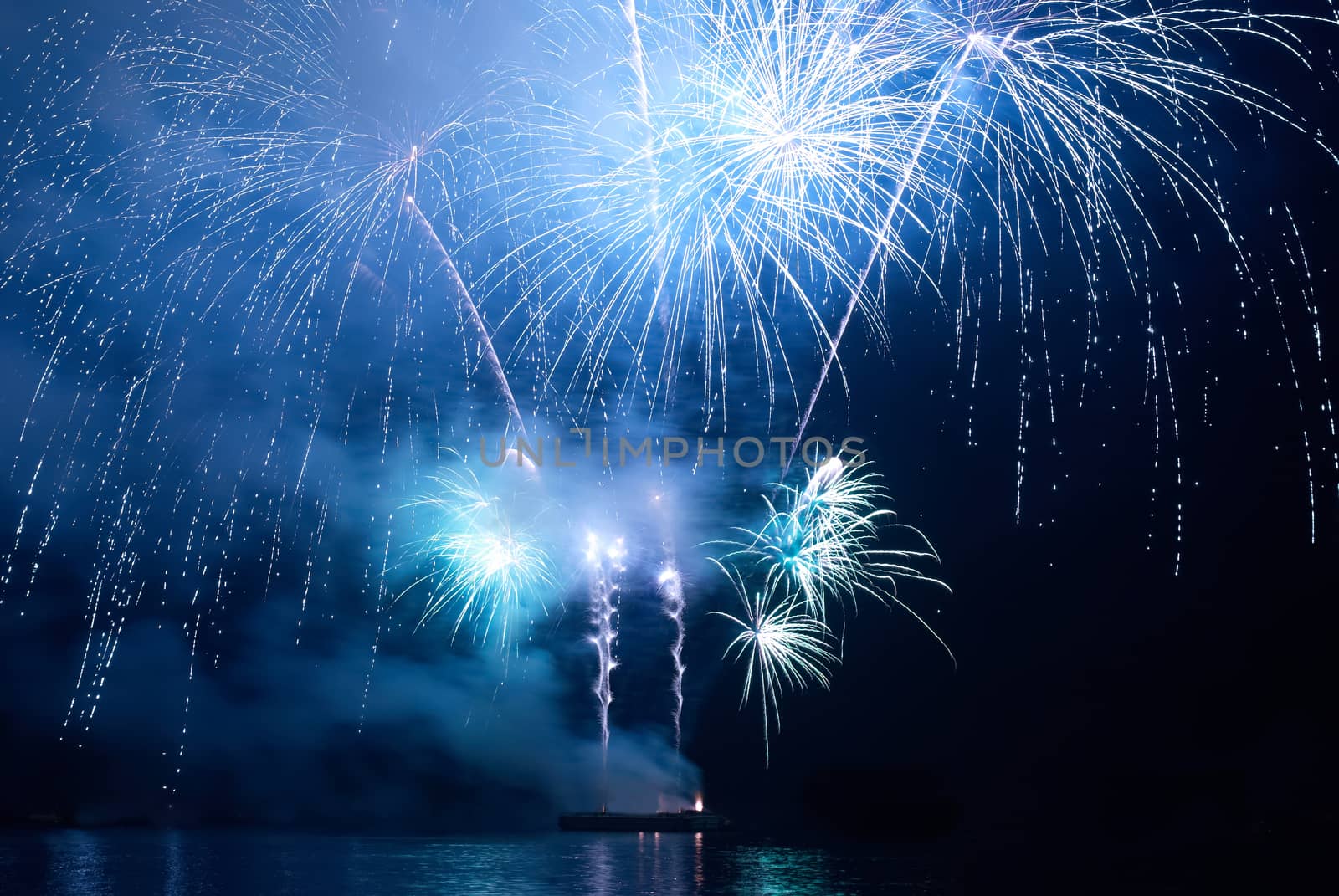 Blue colorful holiday fireworks on the black sky background.