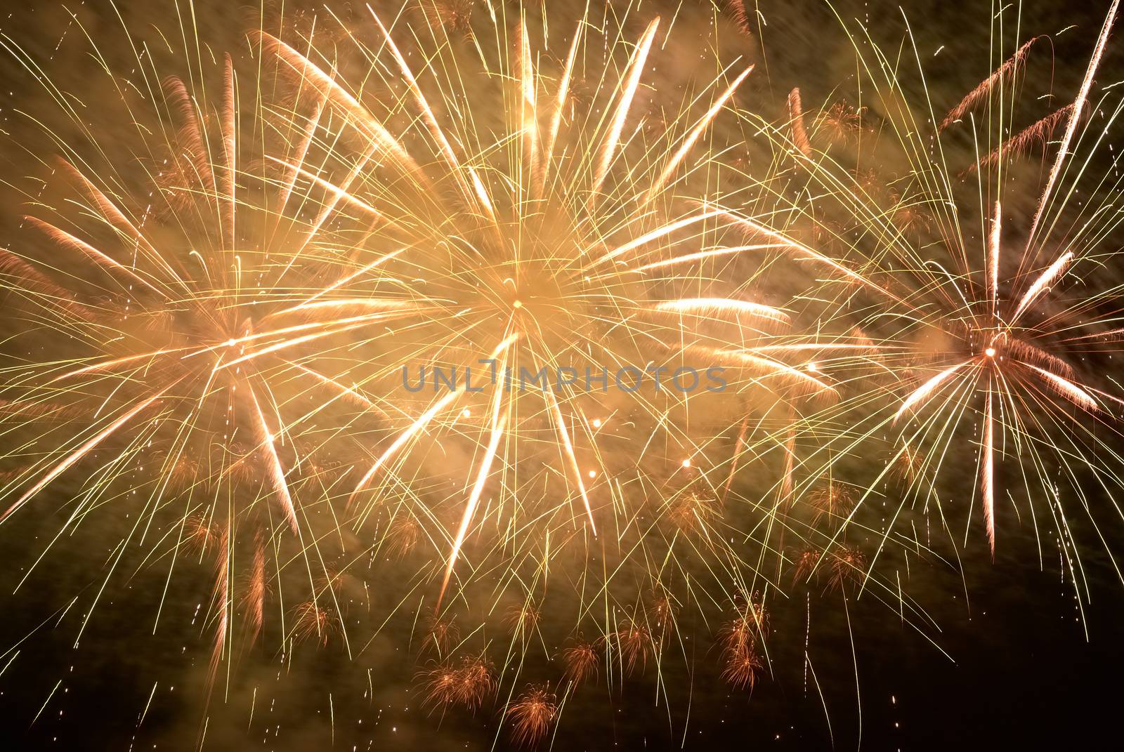 Red amd yellow colorful holiday fireworks on the black sky background.