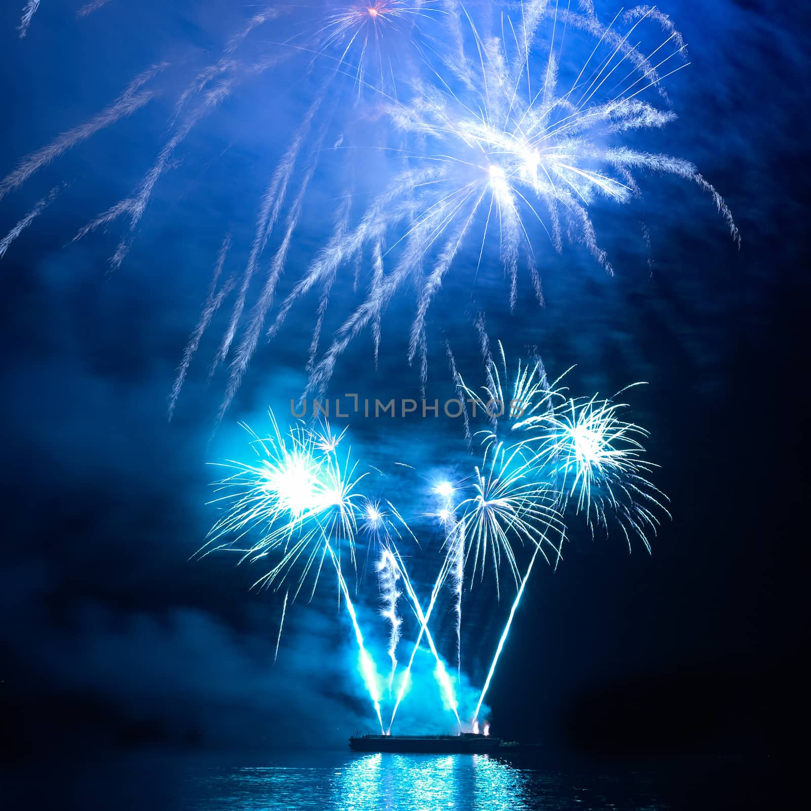 Blue colorful holiday fireworks on the black sky background.