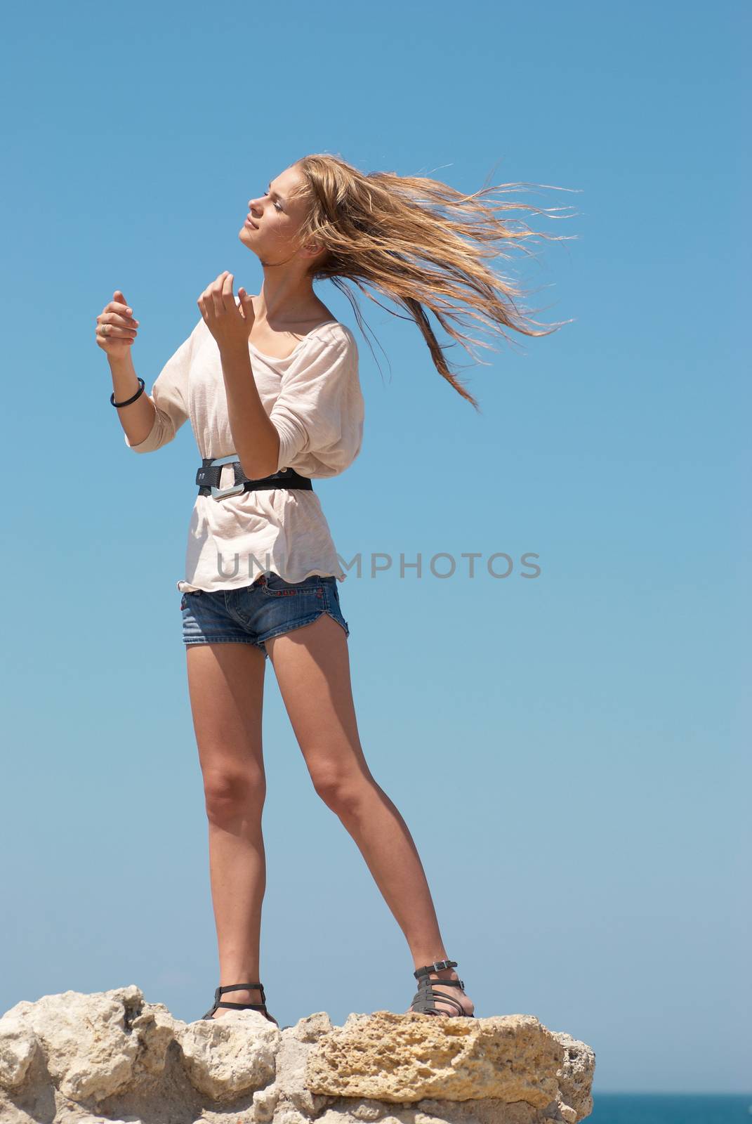 Beautiful blond girl outdoors against the sea