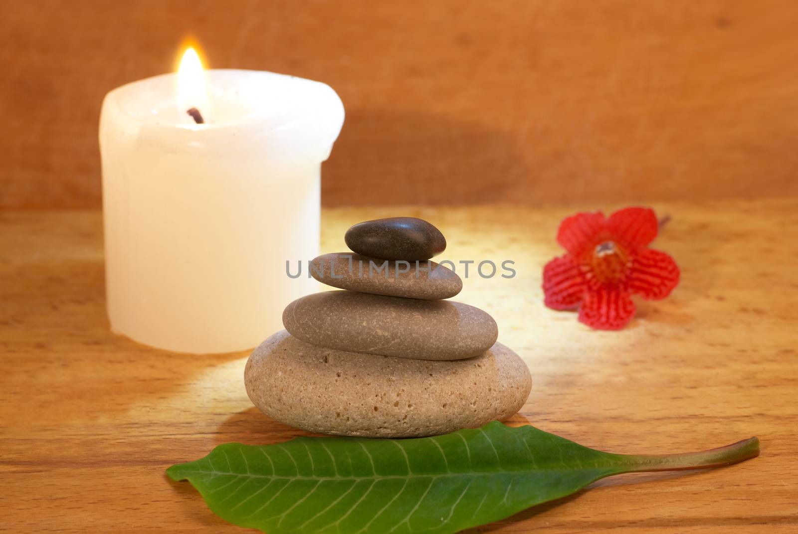 Spa concept with candle zen stones and wooden background