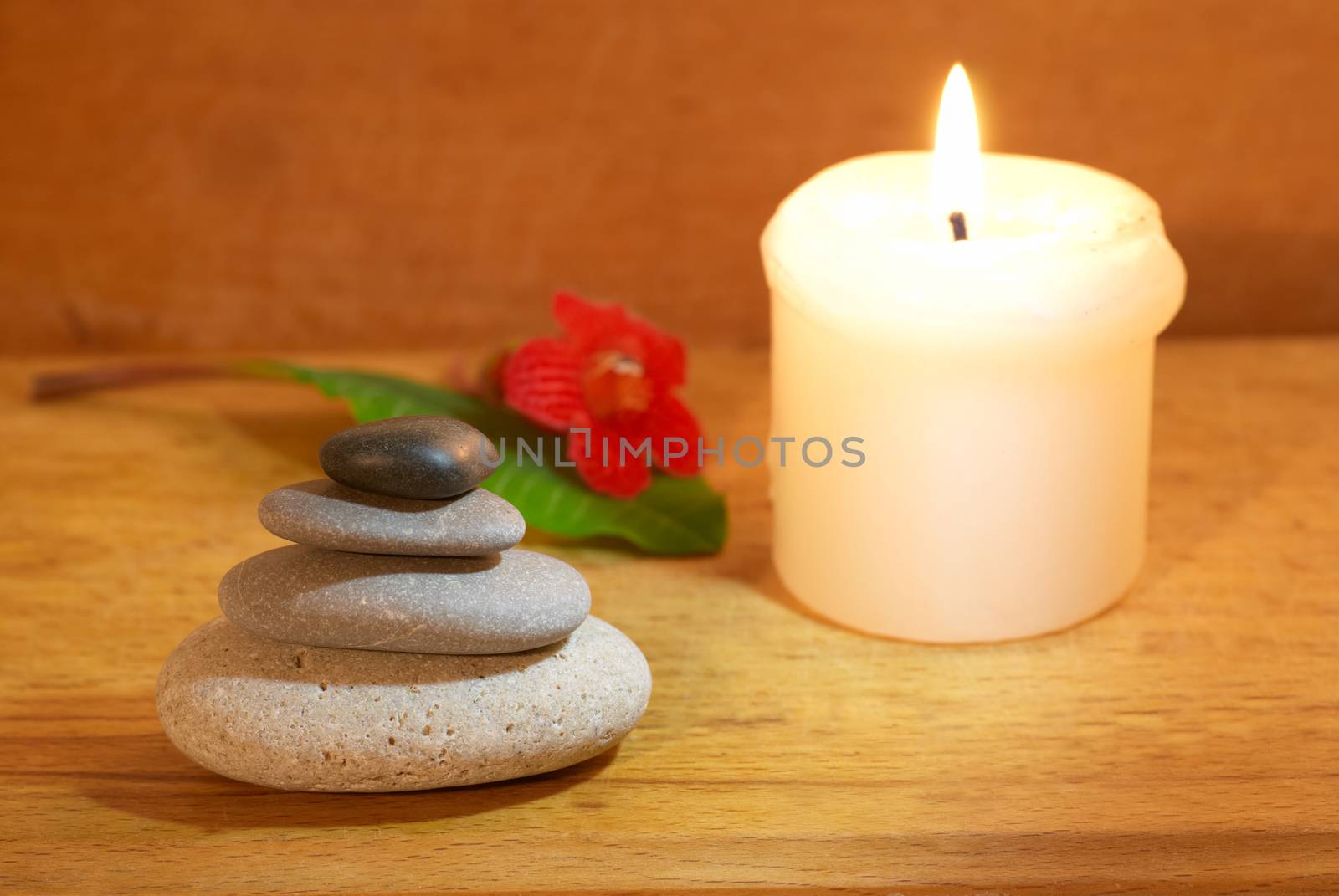 Spa concept with candle zen stones and wooden background