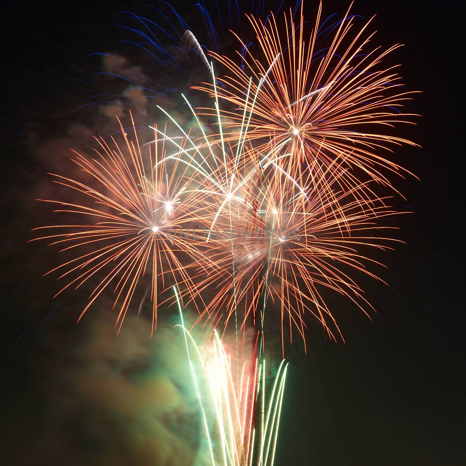 Red colorful holiday fireworks on the black sky background.