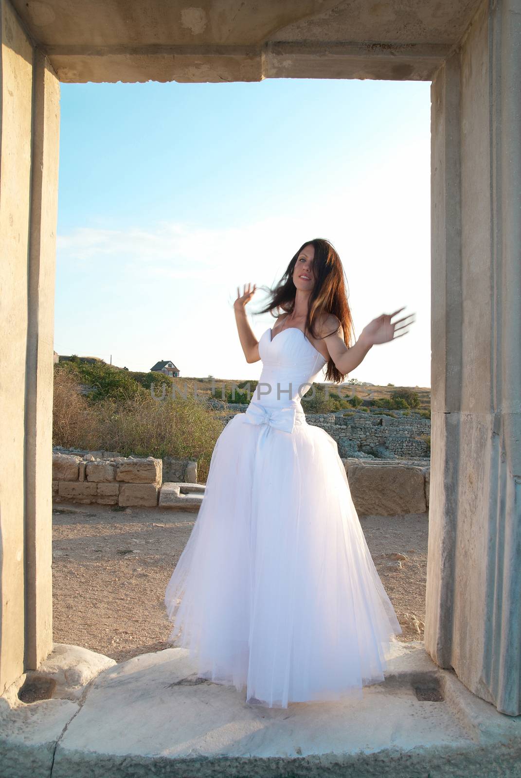 Beautiful bride in the white dress The greece ancient door