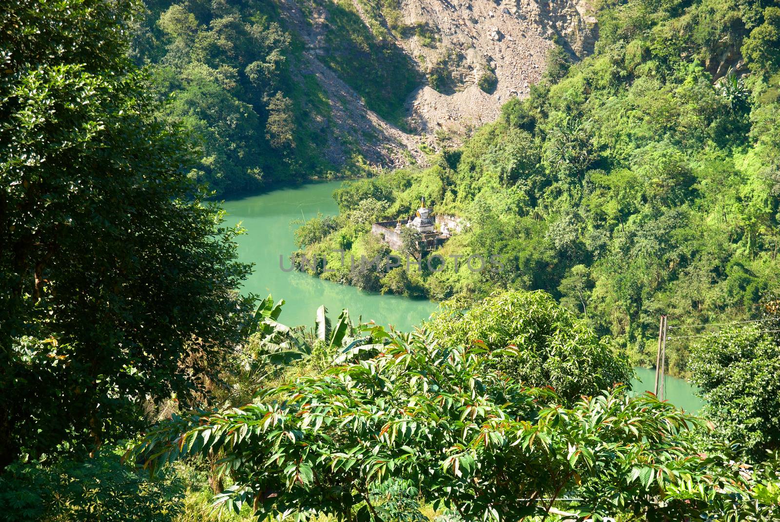 River and indian temple in the forest surrounded by green trees