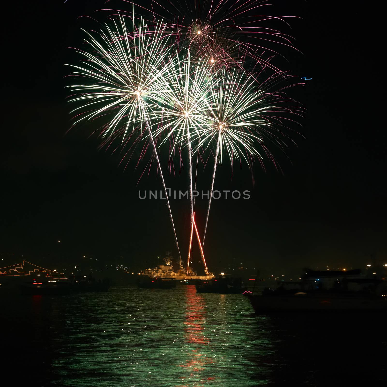 Red colorful holiday fireworks on the black sky background.