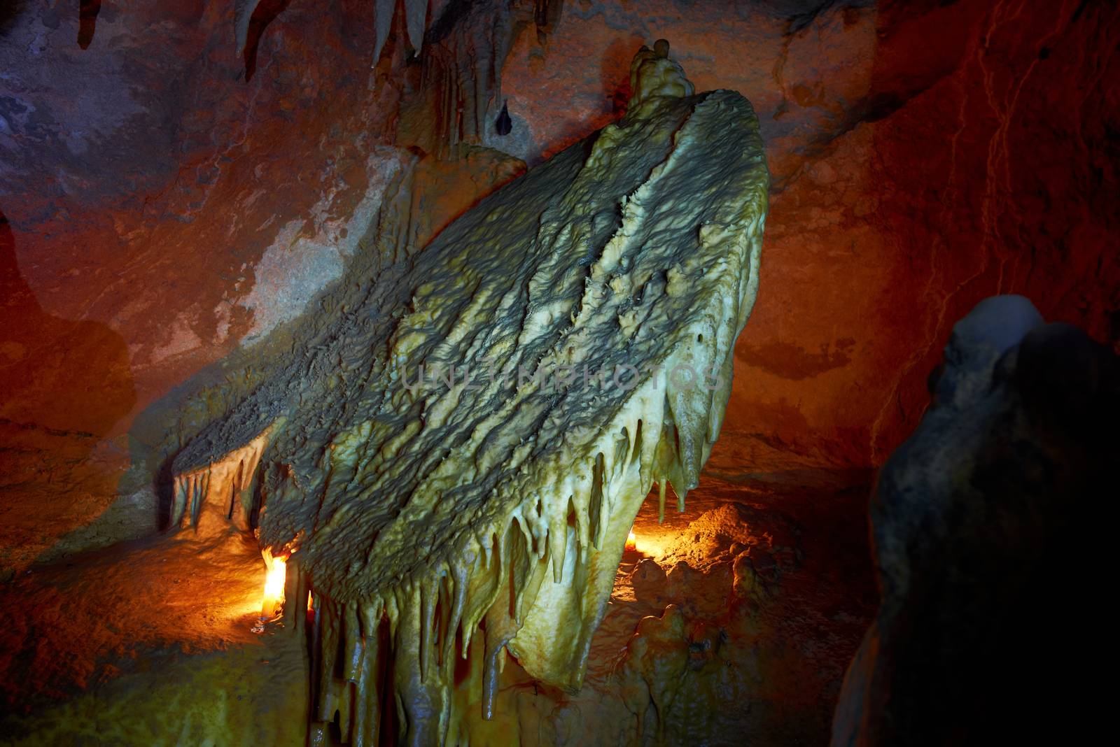 Unique cave formation- disk or sun Casteret. Shooting deep under ground with candle light