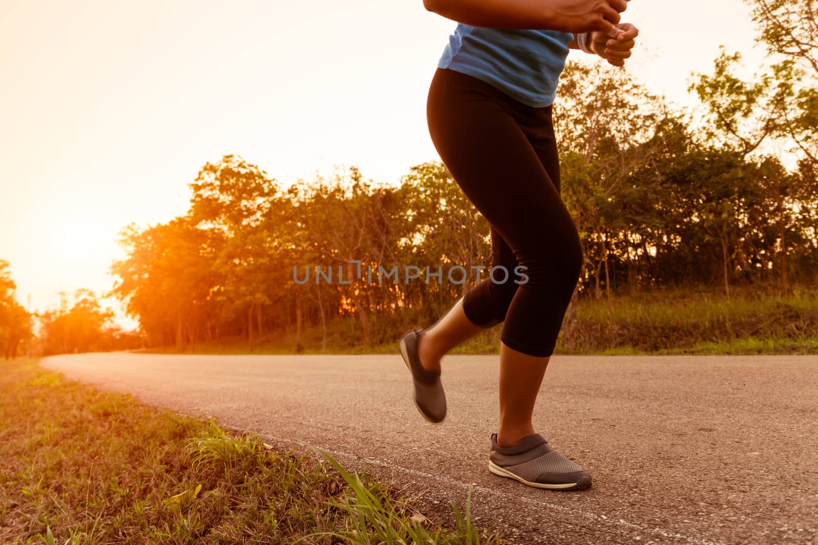 activity woman running on rural road during sunset