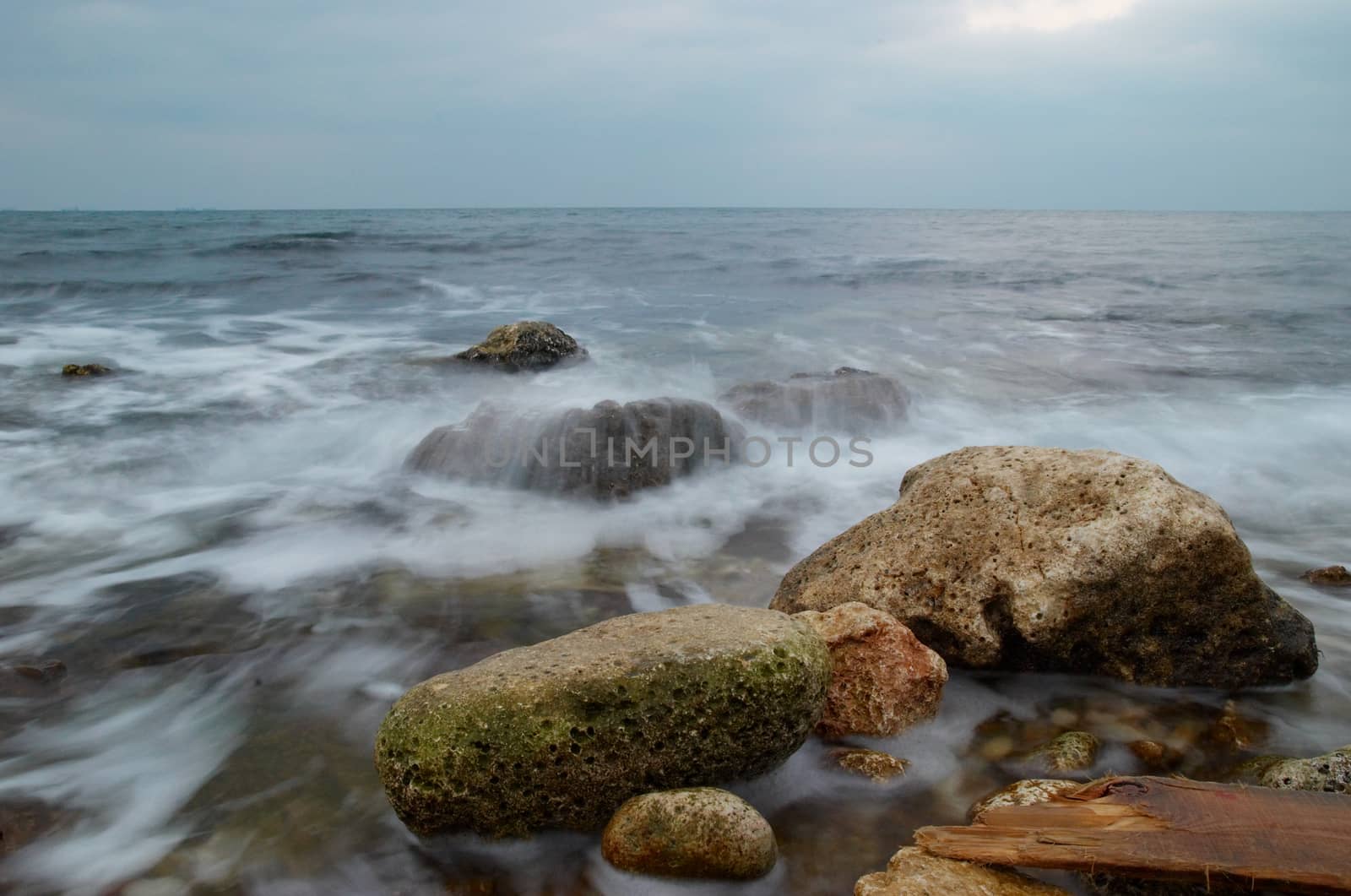 Storm, rock near the shore. by vapi