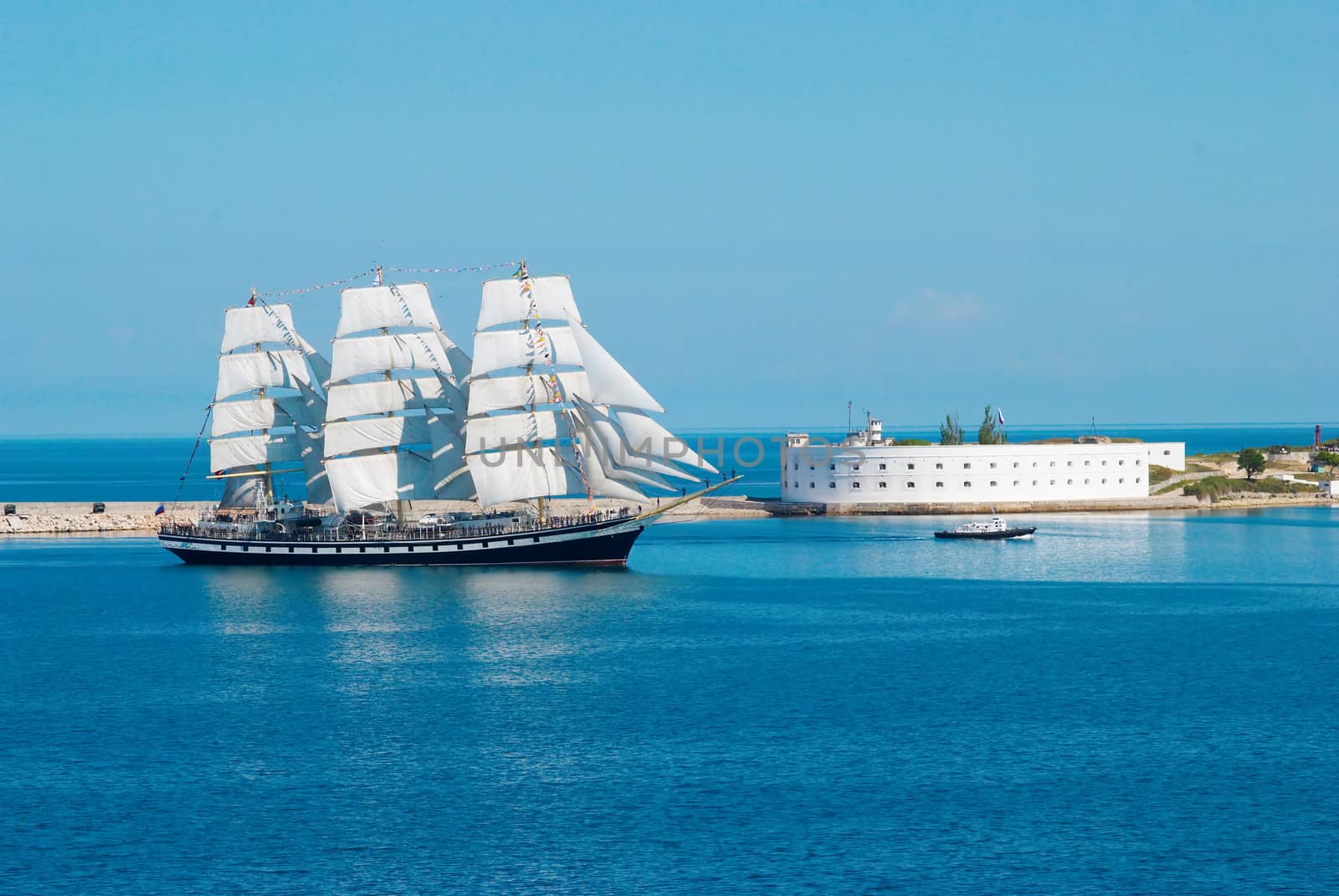 Sailing ship entering to the bay. by vapi