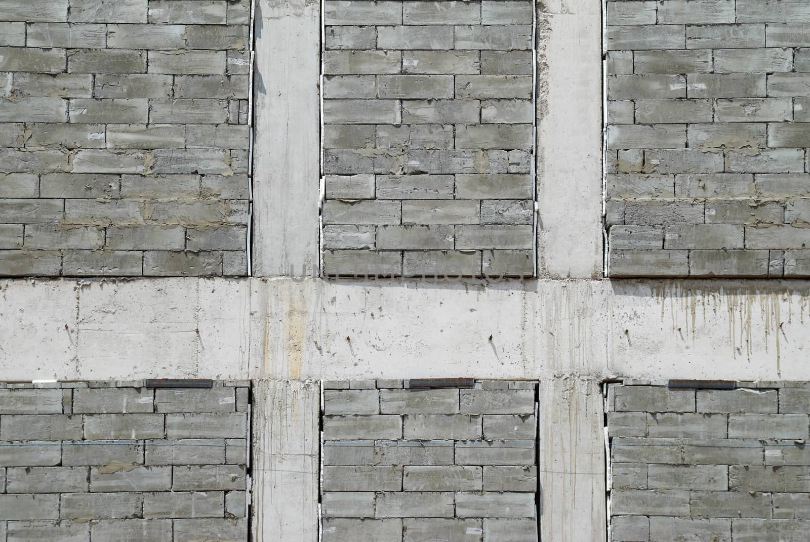 A wall of textured gray construction bricks.