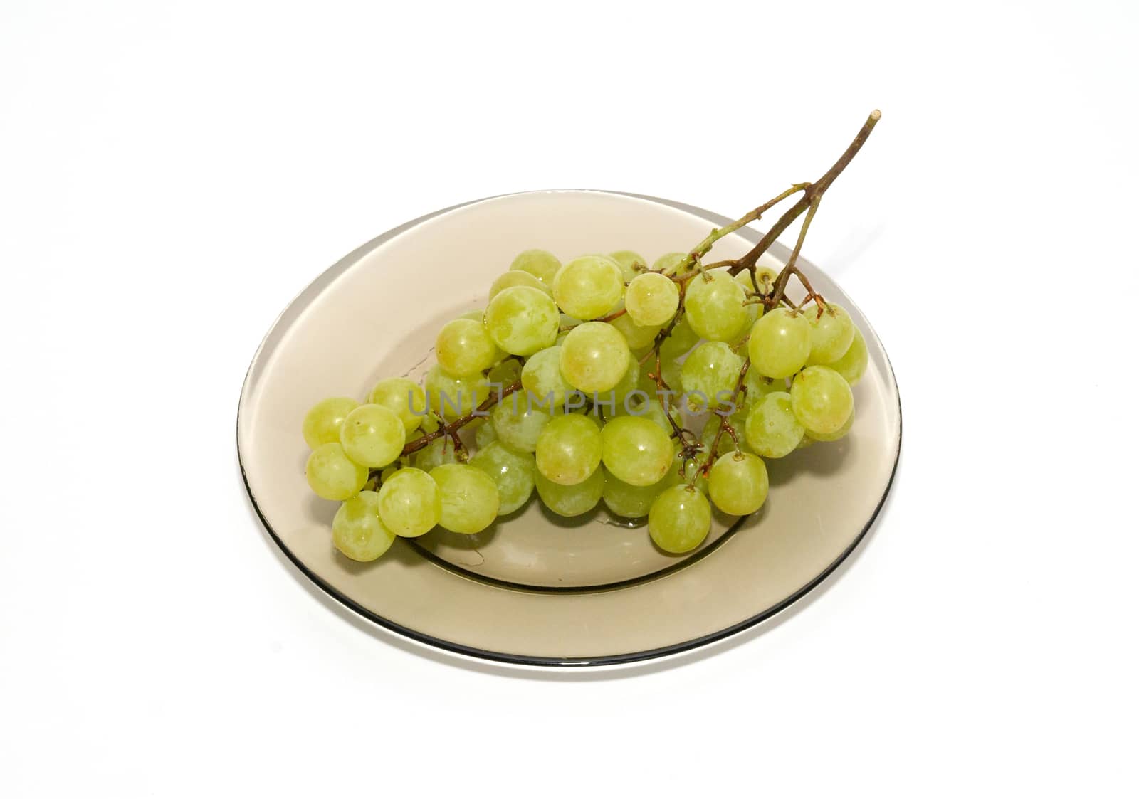 Green grapes on the plate isolated on white. by vapi
