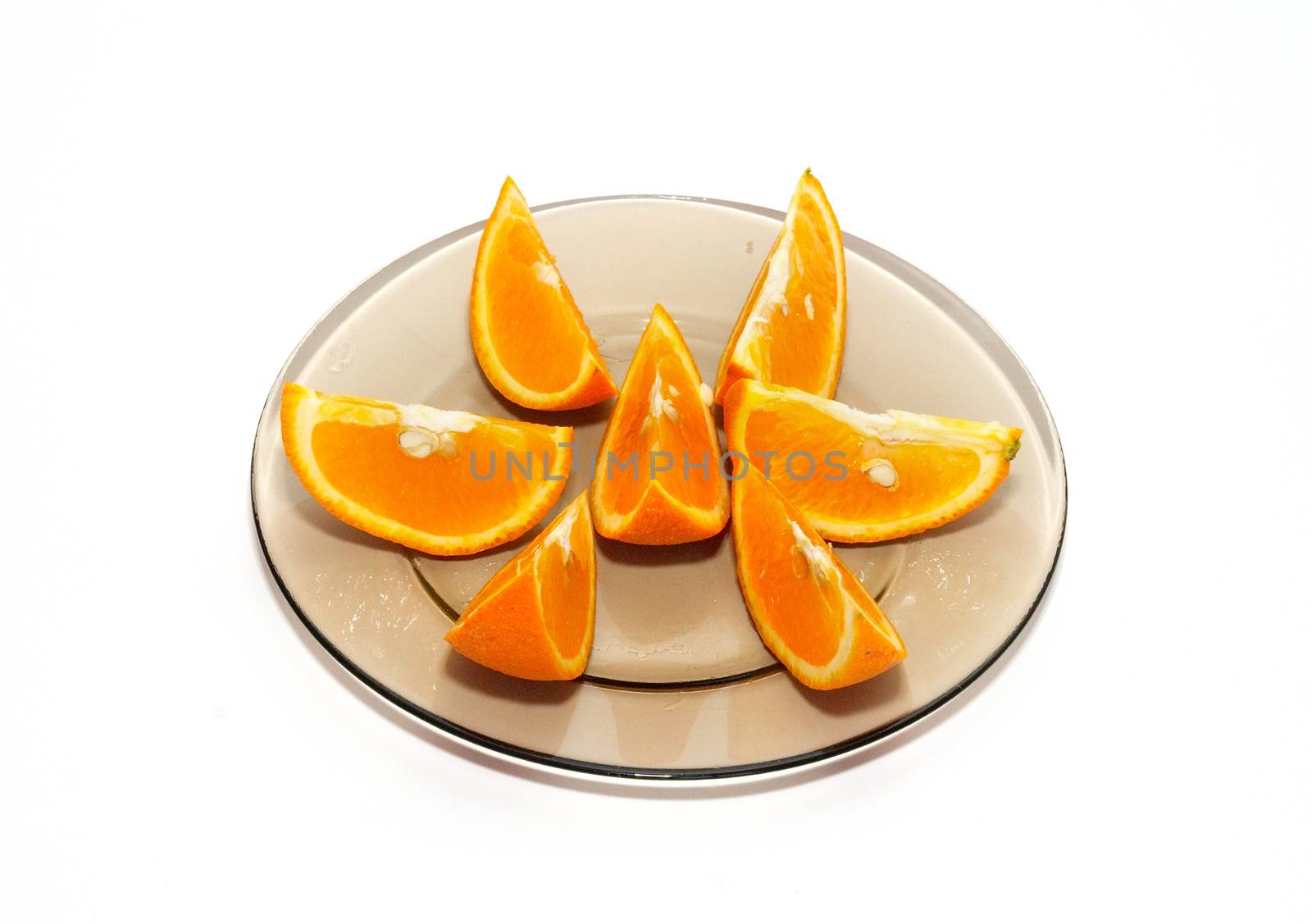 Orange segments on the plate isolated on white.