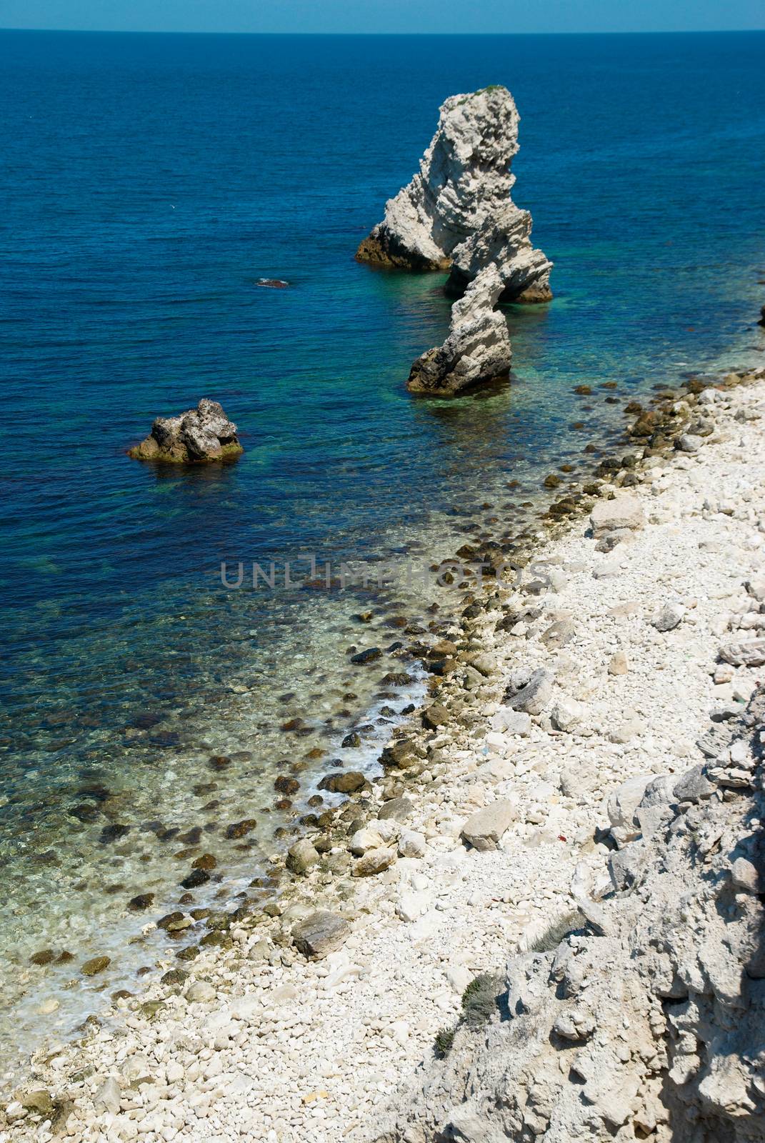 A coastline with many big rocks.