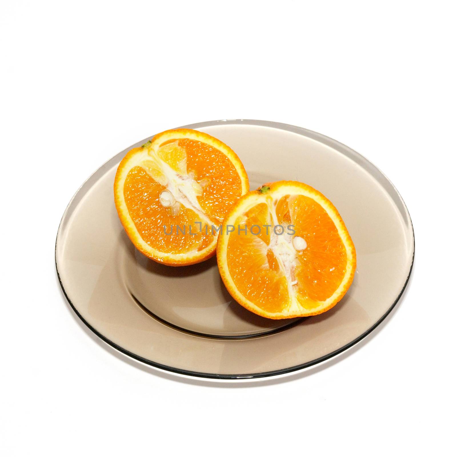 Orange segments on the plate isolated on white. by vapi