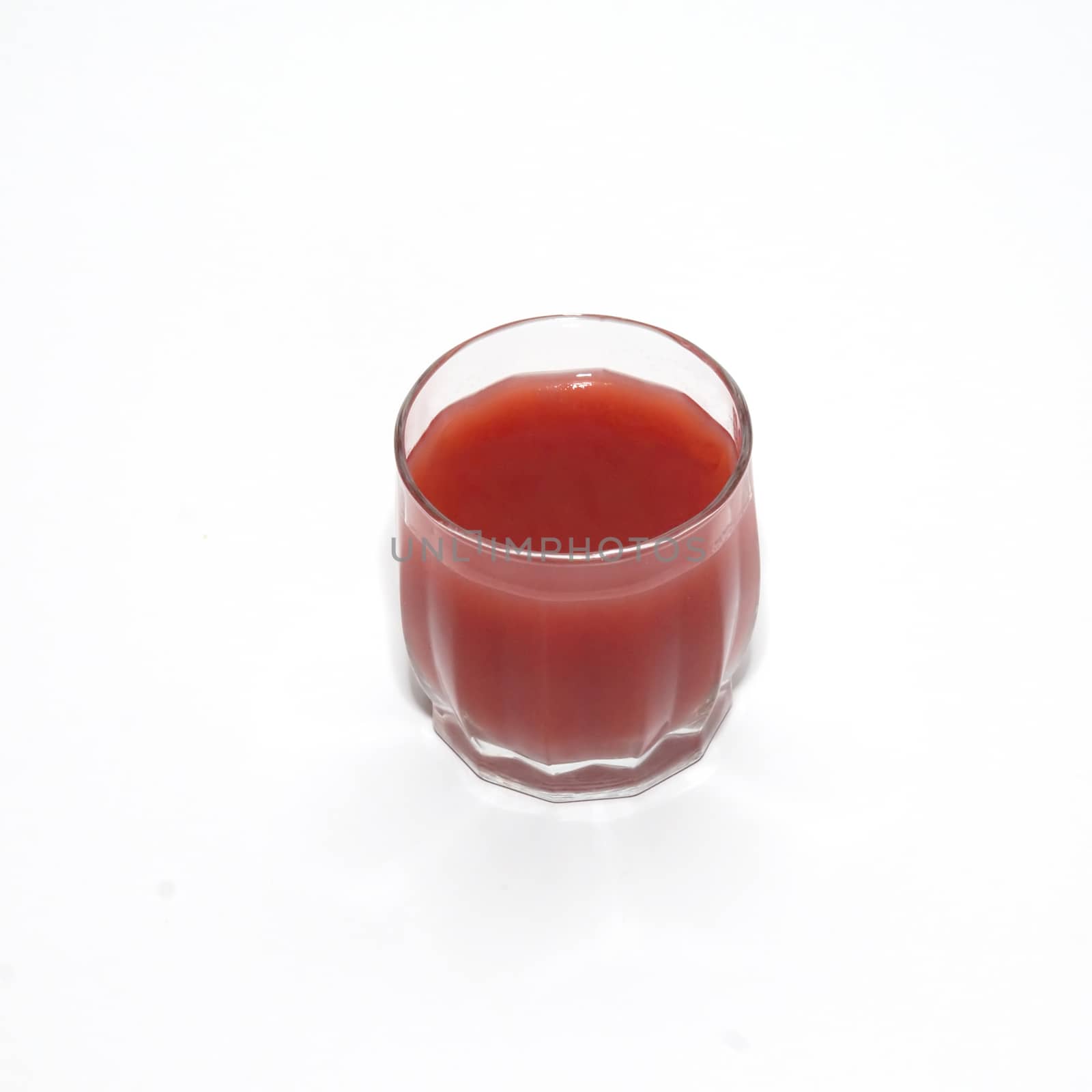 Juice in glass isolated on white.