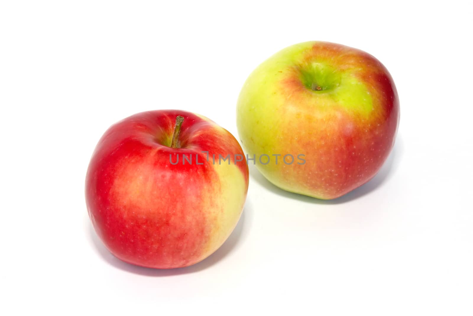 Two red fresh apples isolated on white.
