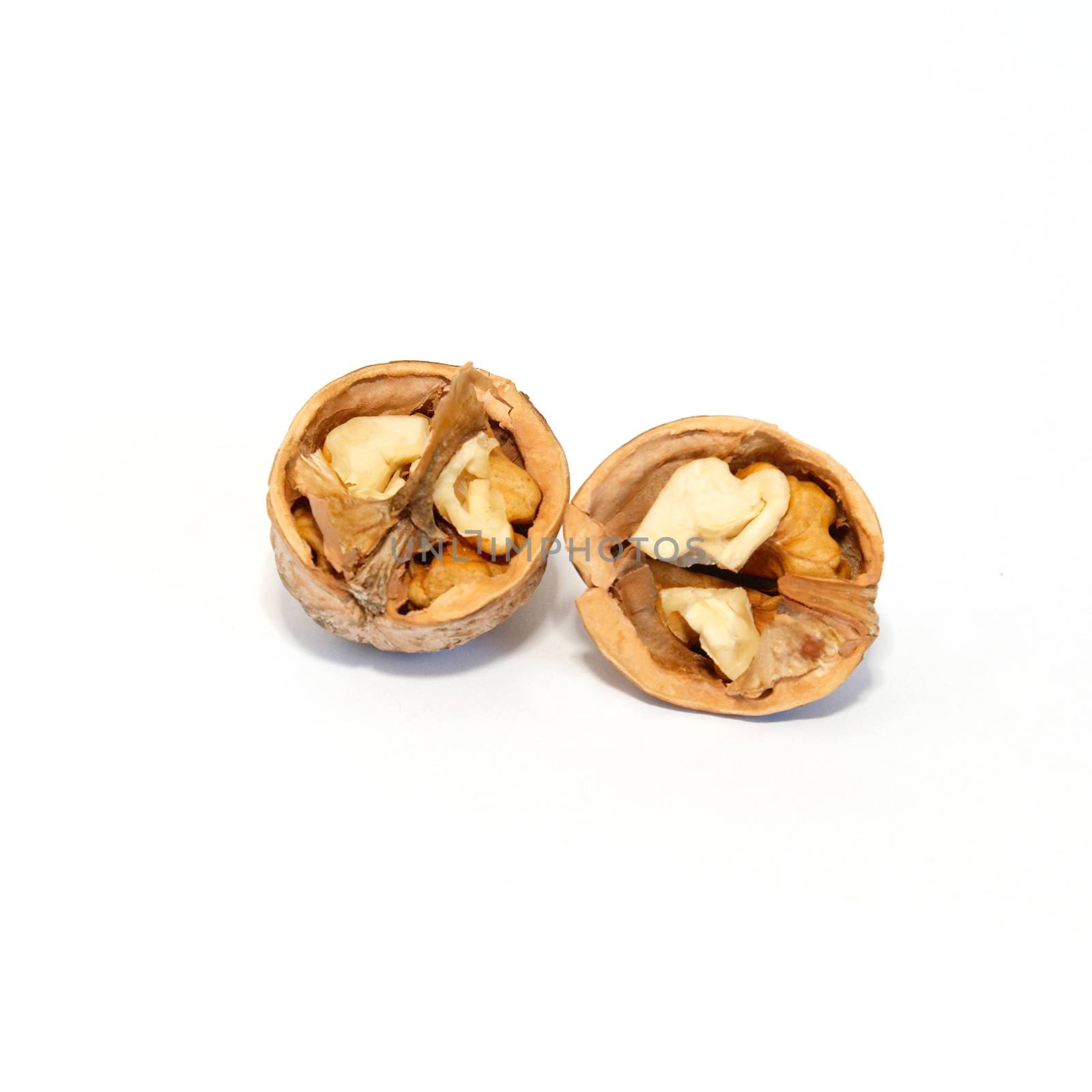 Two halves of walnut isolated on white.